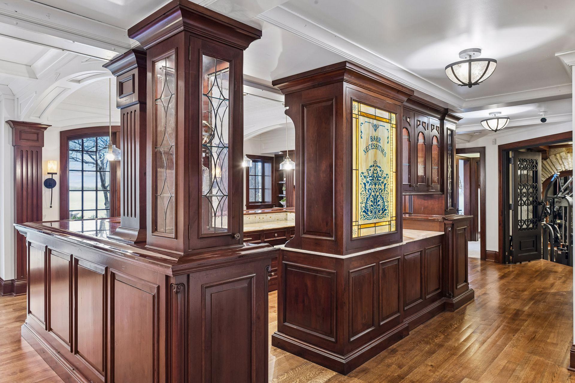 Beautiful, glass showcase pillars add to the all around beauty and high end details of this amazing bar.