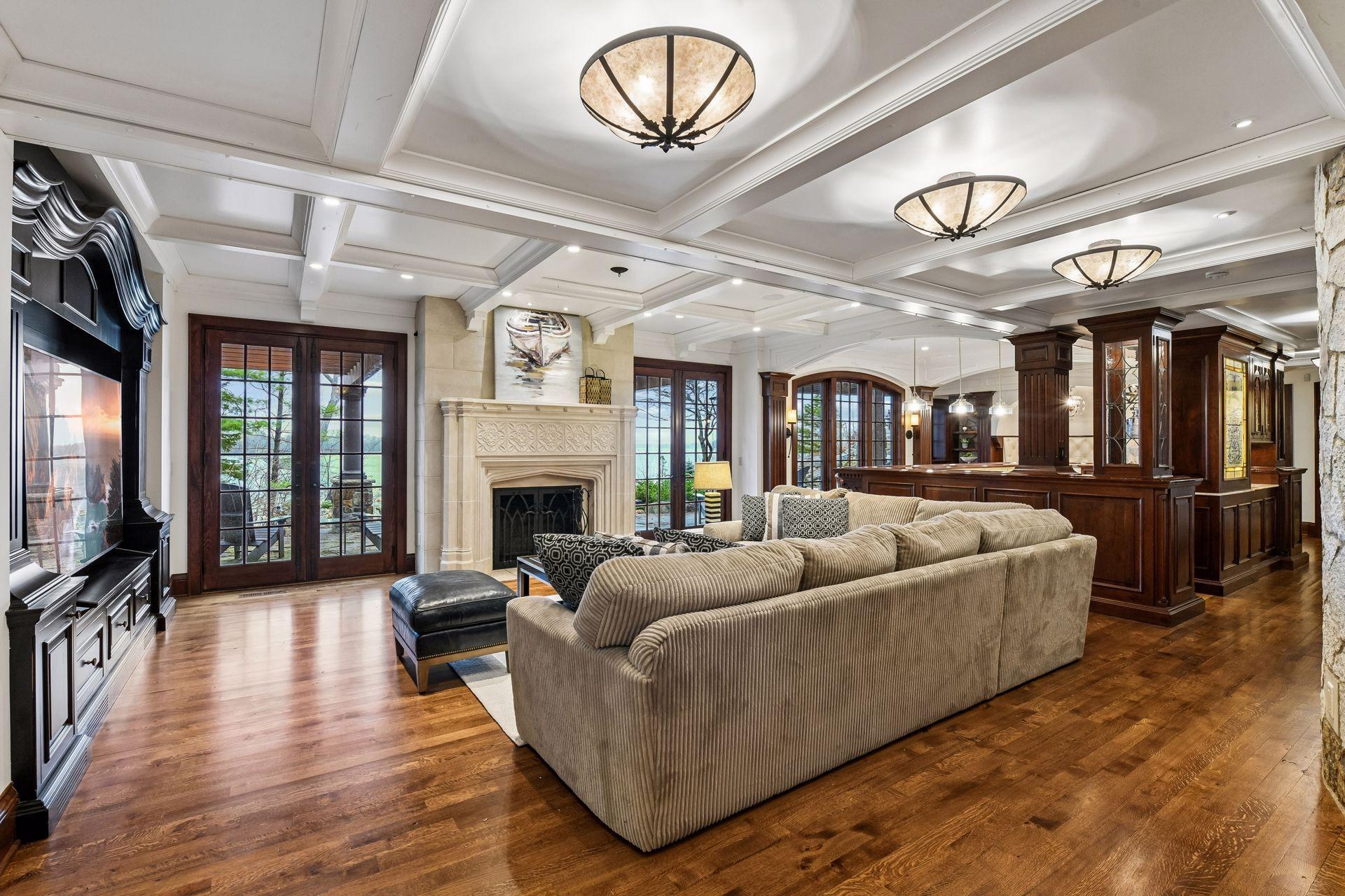 This angle shows how large the room is and the multiple ways to get outside and enjoy the lake views. Wide open space and wonderful for everyday life or entertaining.