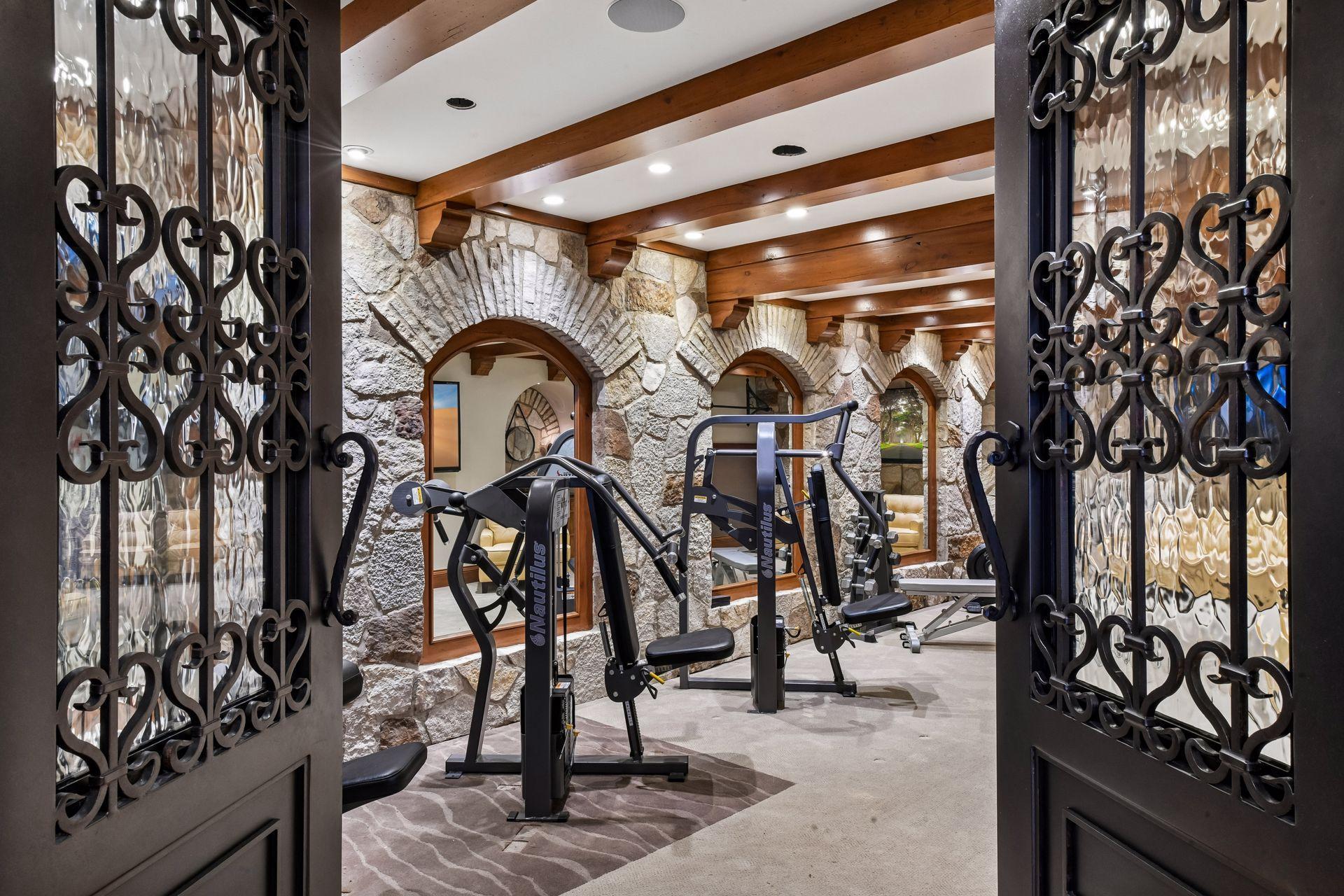 Enter the work-out room through Custom wrought iron doors.