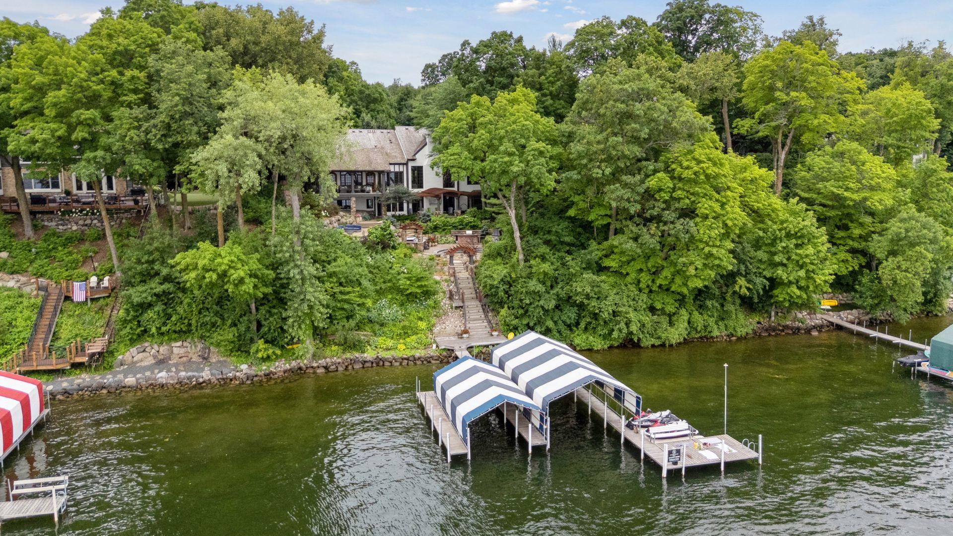 Dock has 2 boat slips and slip covers, jet ski ramps, and a large swim platform with bench.