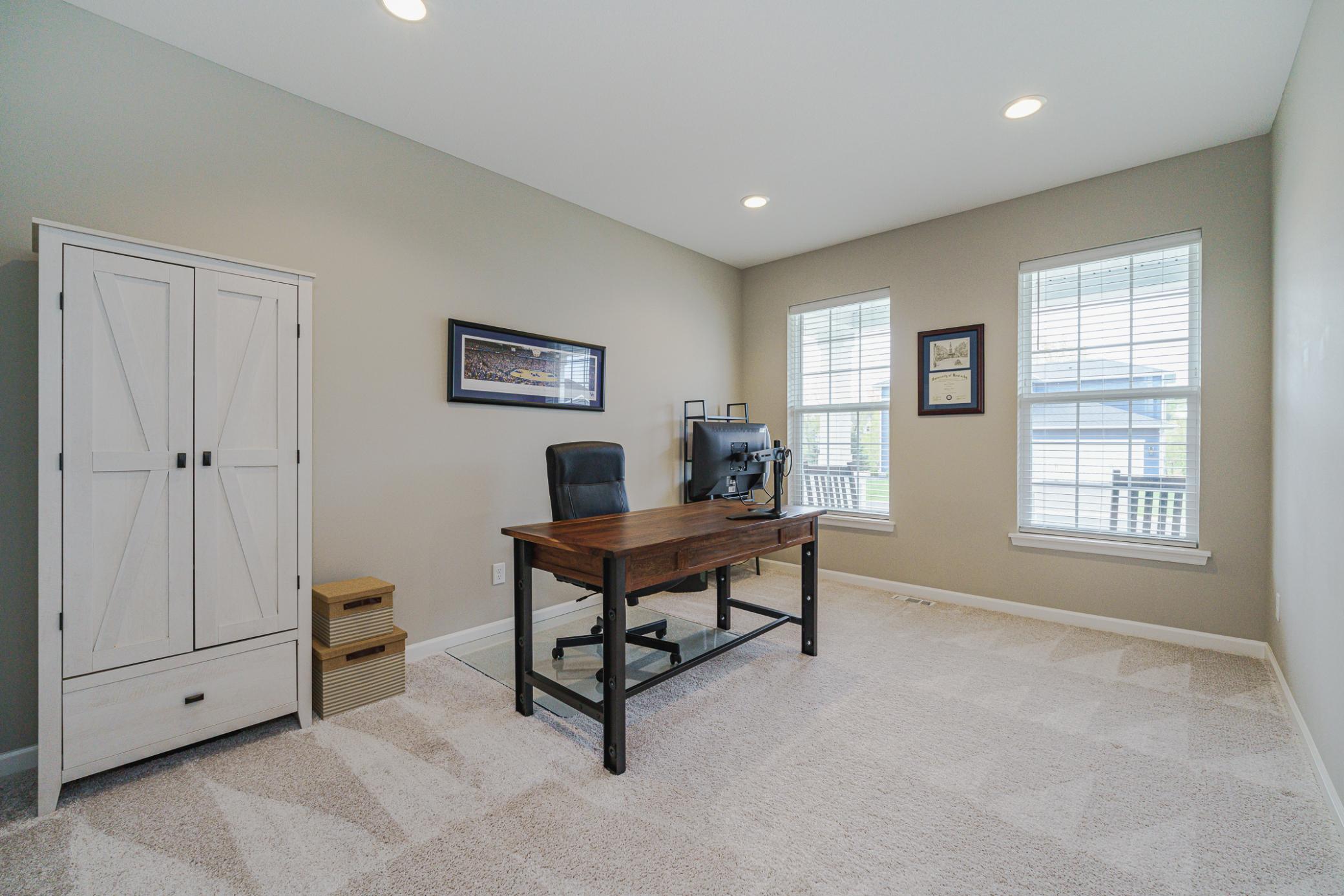 The office lies off the entry foyer and can be closed off with a glass door. The office has recessed lighting and overlooks the porch
