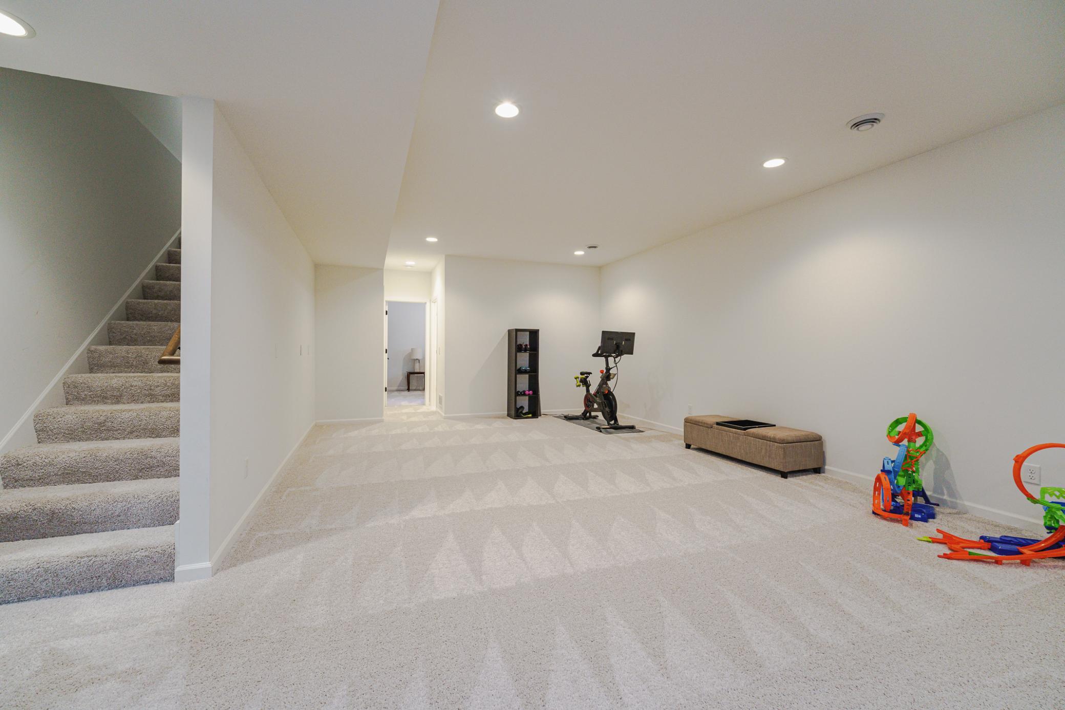 The lower level is light and bright, with 9-foot ceilings and lots of recessed lighting. The family room and amusement area is open, bright and comfortable. It features neutral paint and carpet.