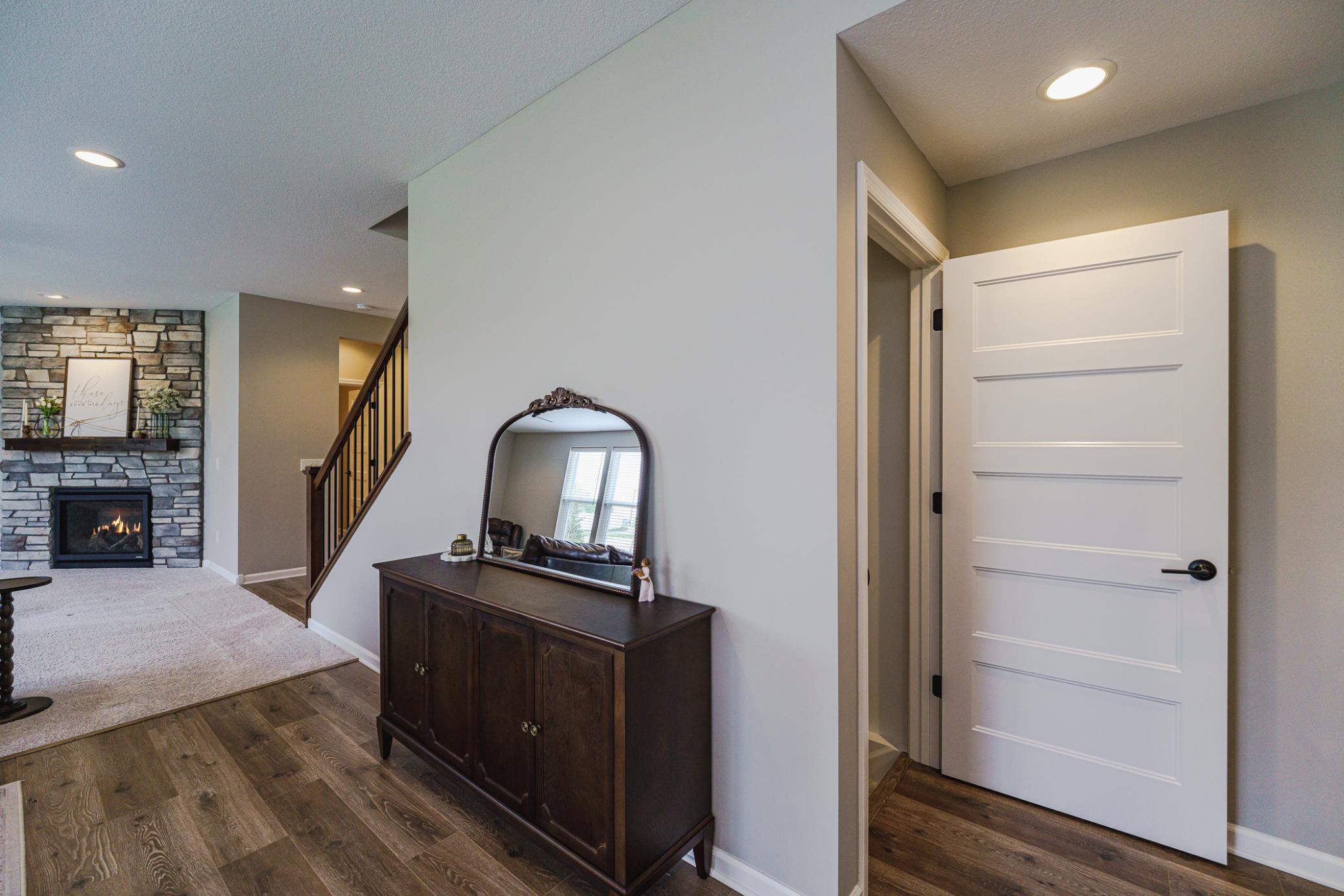 The family room has a stone fireplace in the corner.