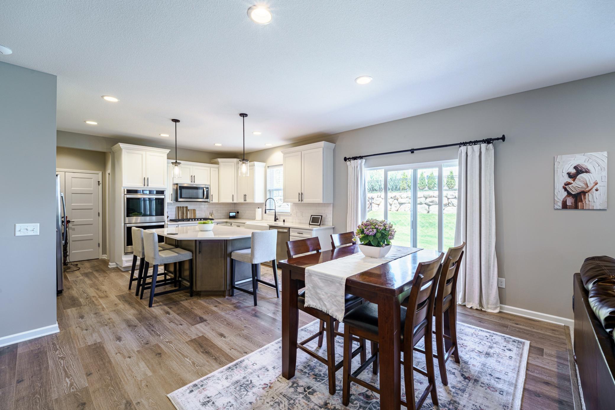 This stunning kitchen offers a HUGE dining space that can accommodate your table, with or without a leaf, plus bar seating at the island.