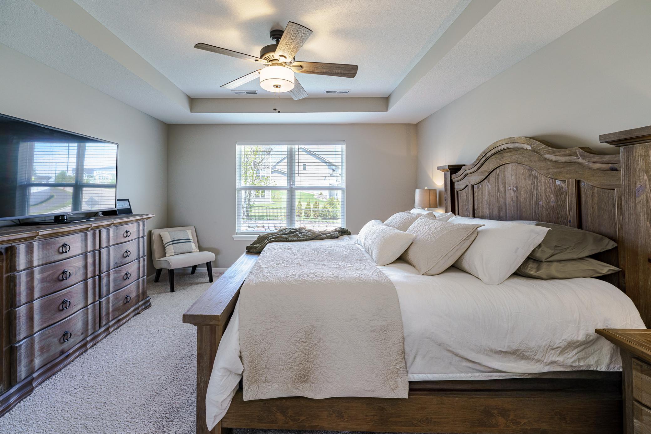 The owner’s suite is generous and can accommodate a king-sized bed. This room receives wonderful natural light from large windows.
