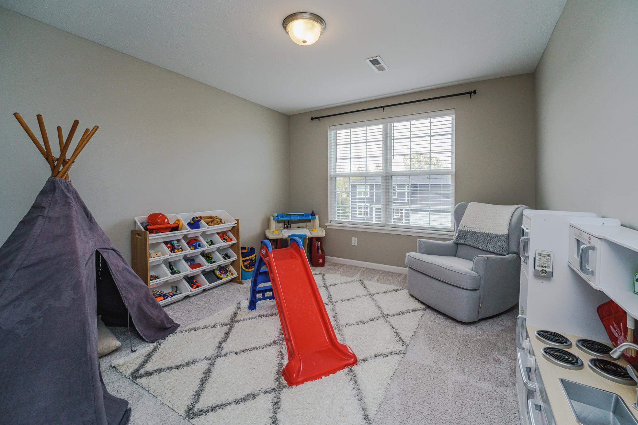 This large bedroom has a walk-in closet and double windows.