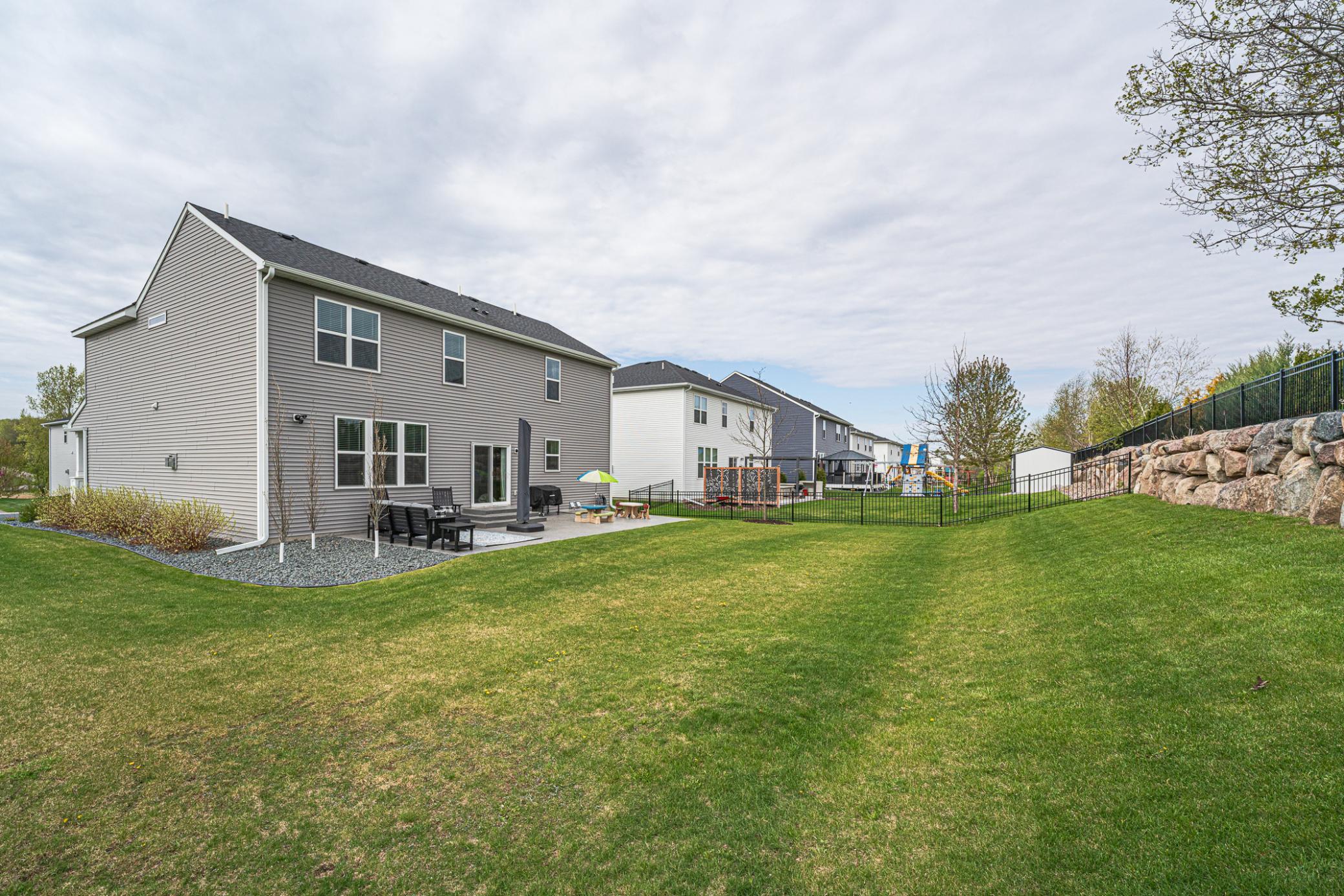 Walk out to the backyard directly from your kitchen and enjoy endless options for relaxation, play and rest, on this huge patio with an umbrella, as well as a flat, functional backyard!