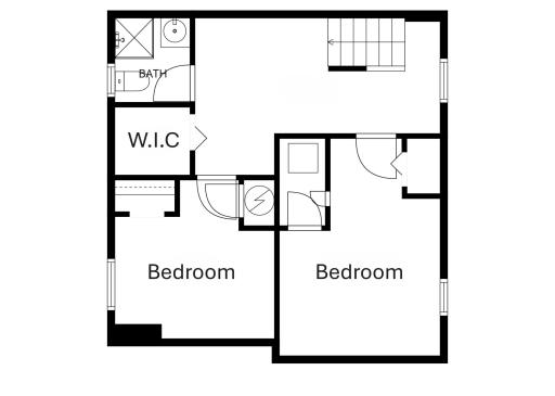 Basement floor plan reveals two bedrooms a bathroom, a walk-in-closet that can hold a washer and dryer and a nook currently set up with a mini 2nd kitchen setup