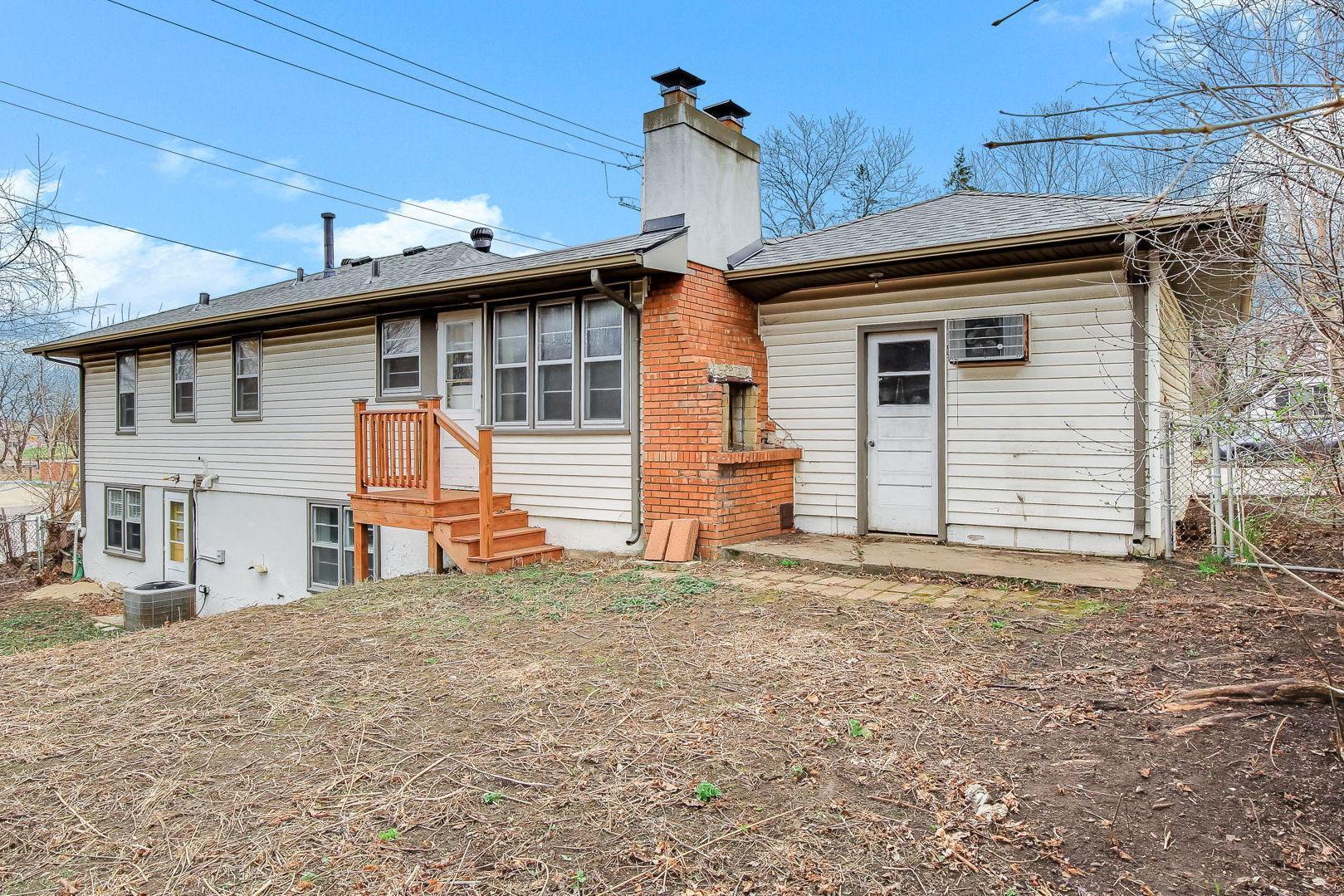 Exterior back of home with stair and walk-out access to the back yard....