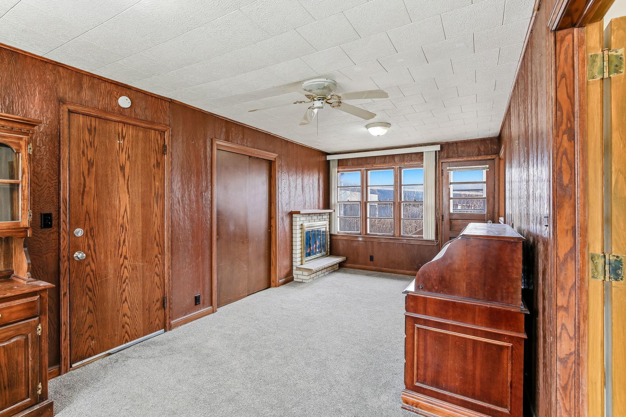 Main floor family room with woodburning fireplace and door with access to the back yard...