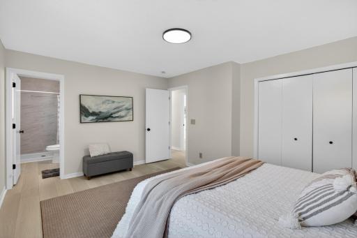 Upper level: primary bedroom with 3/4 bathroom