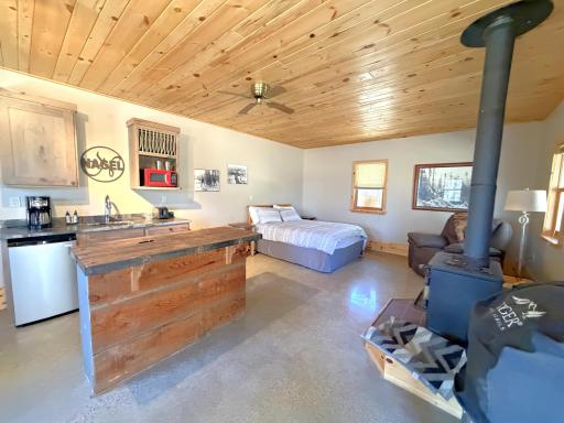 Dining, living & bedroom area with wood free standing stove. Turn key and ready to go!