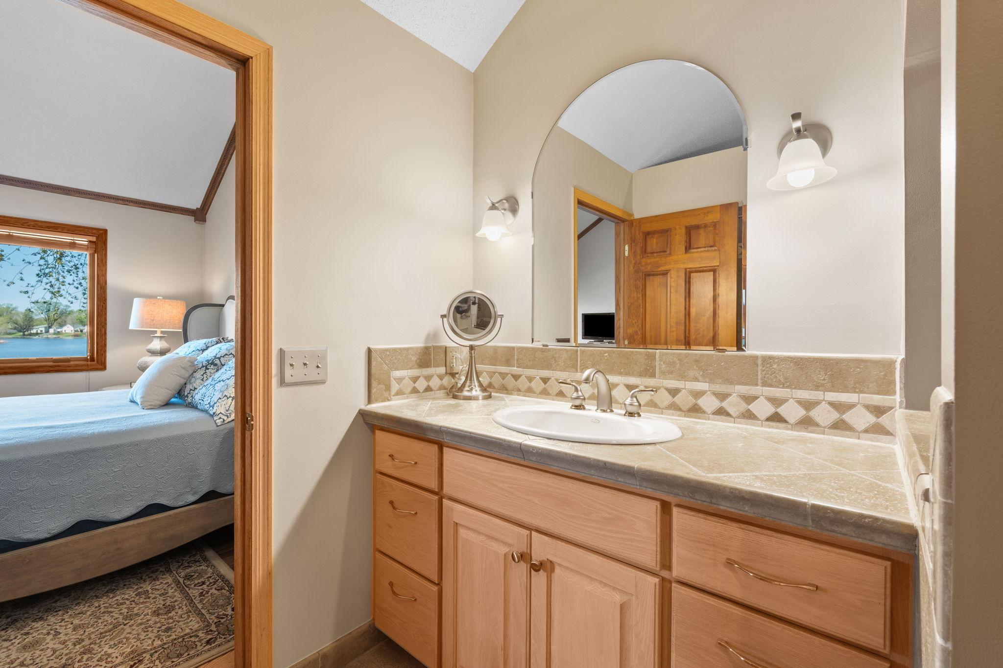 A spacious vanity provides ample room for daily routines, with plenty of storage and counter space for added convenience.