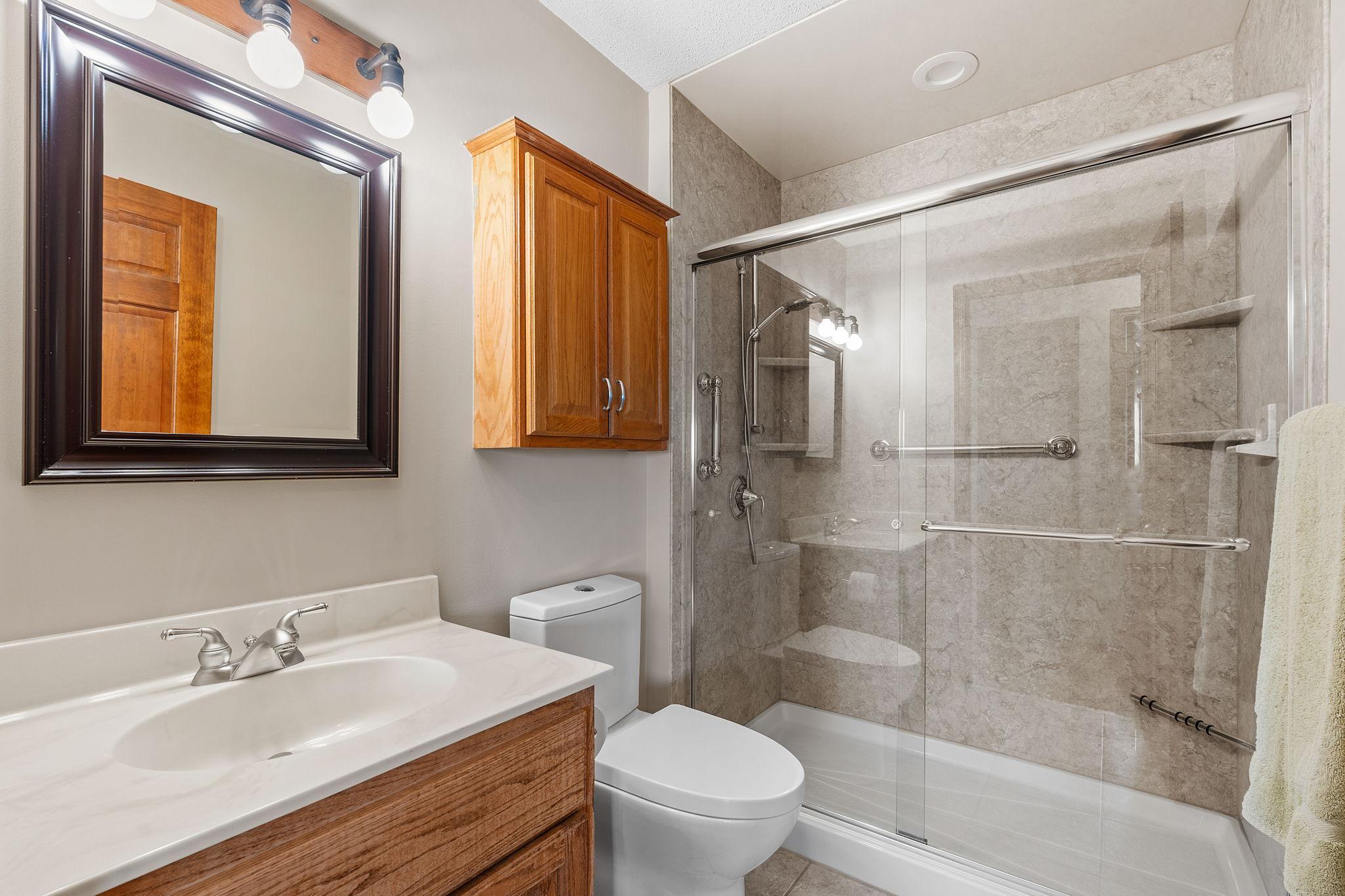 A full bathroom on the upper level includes a shower, offering convenience and functionality for daily routines.
