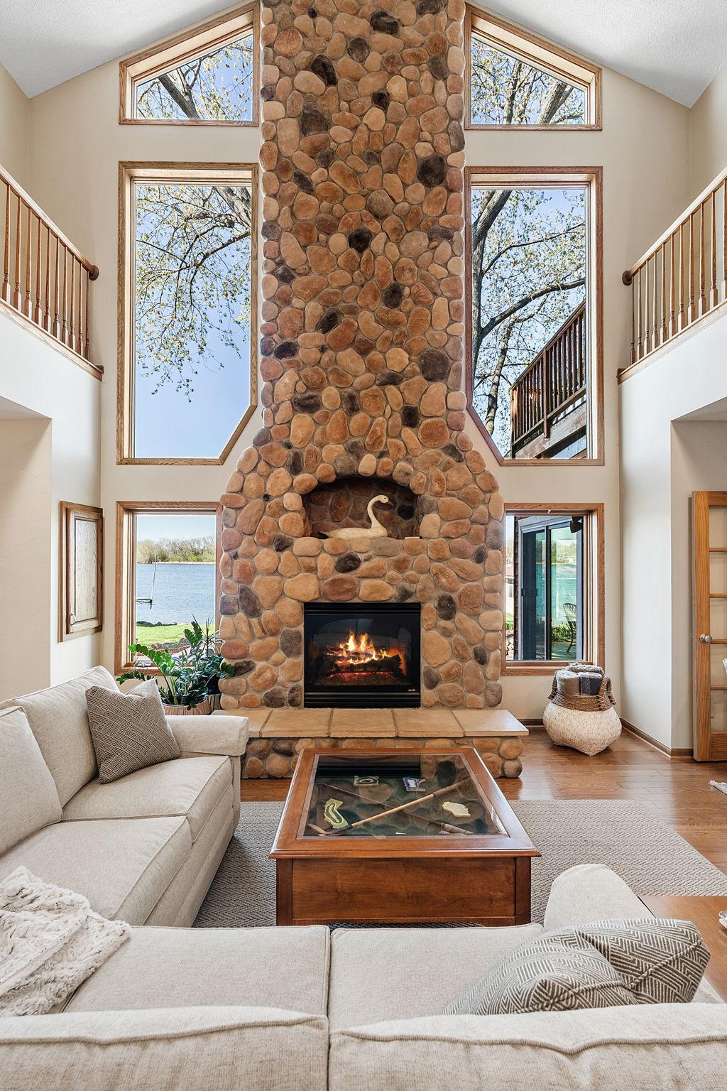A floor-to-ceiling stone fireplace anchors the great room, adding warmth and character.