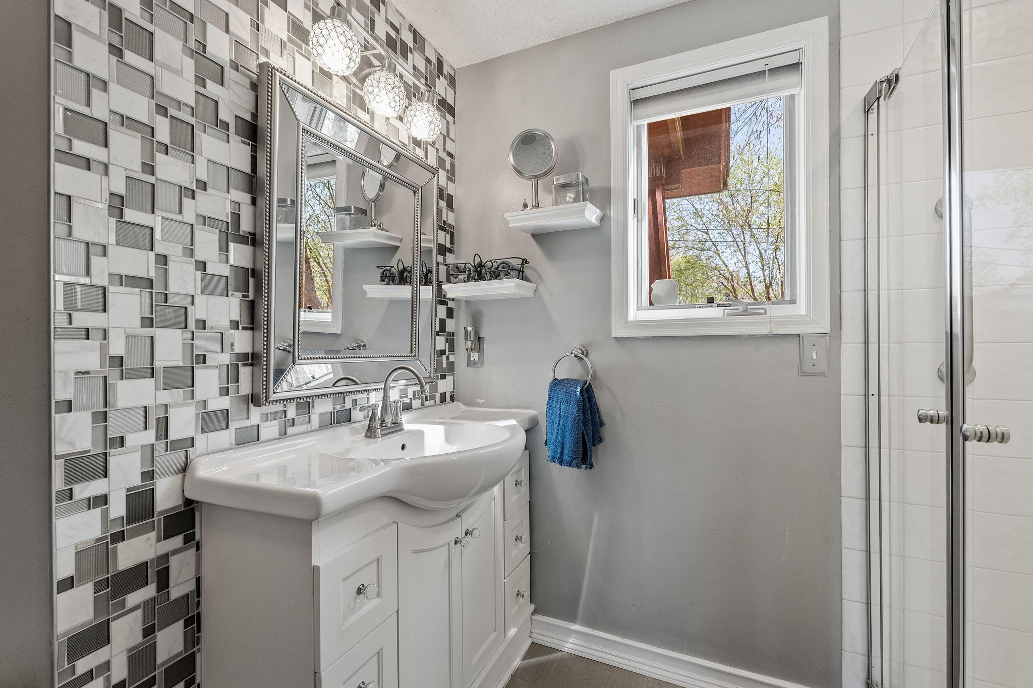 A stylish 3/4 bathroom on the main level features modern finishes and a clean design. It adds convenience for guests and daily use.