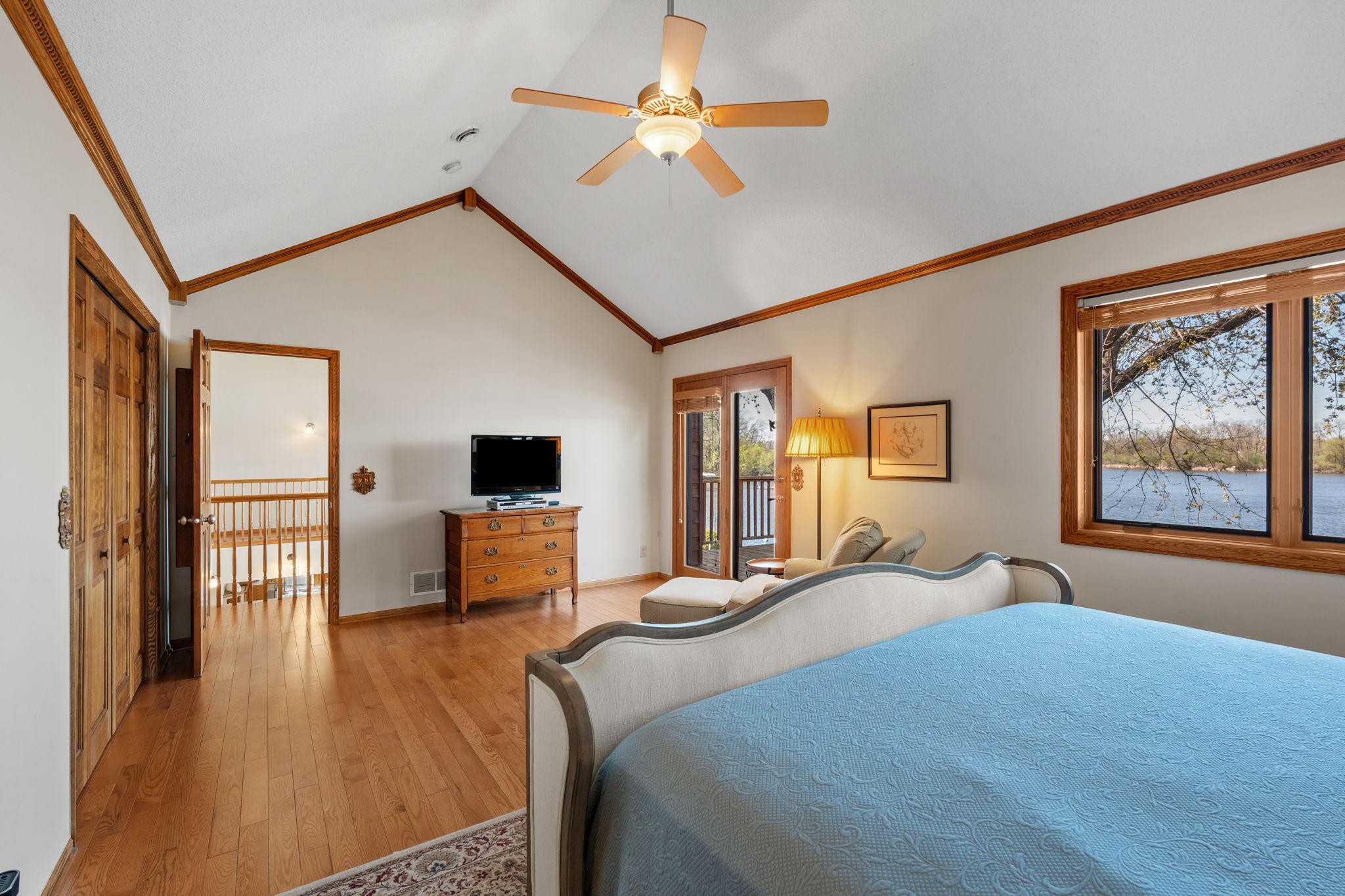 The primary bedroom features vaulted ceilings and direct access to a private deck. It’s a bright and relaxing retreat with beautiful views.