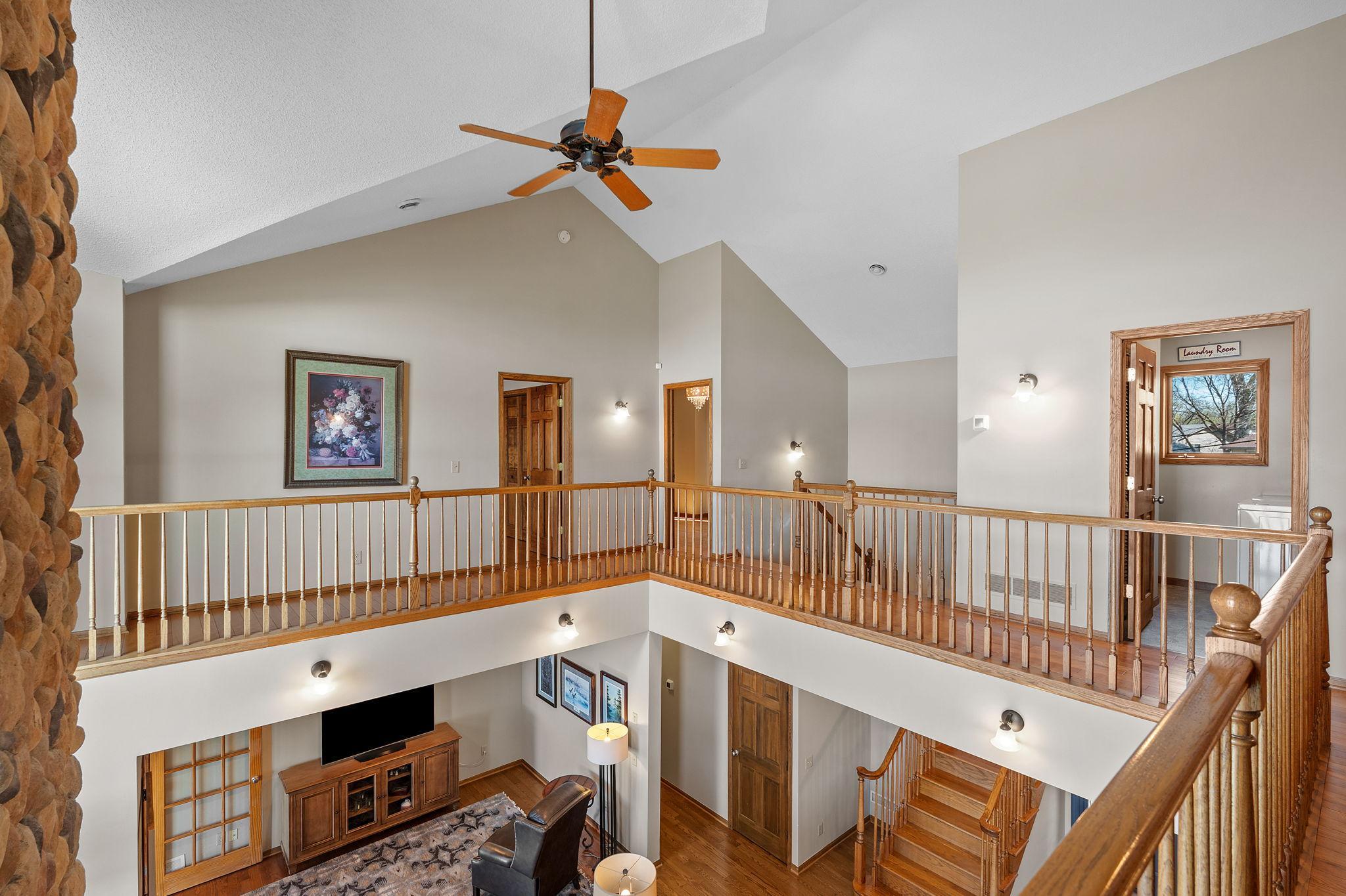The open-to-below design connects the upper level to the great room, creating a sense of space and architectural interest throughout.