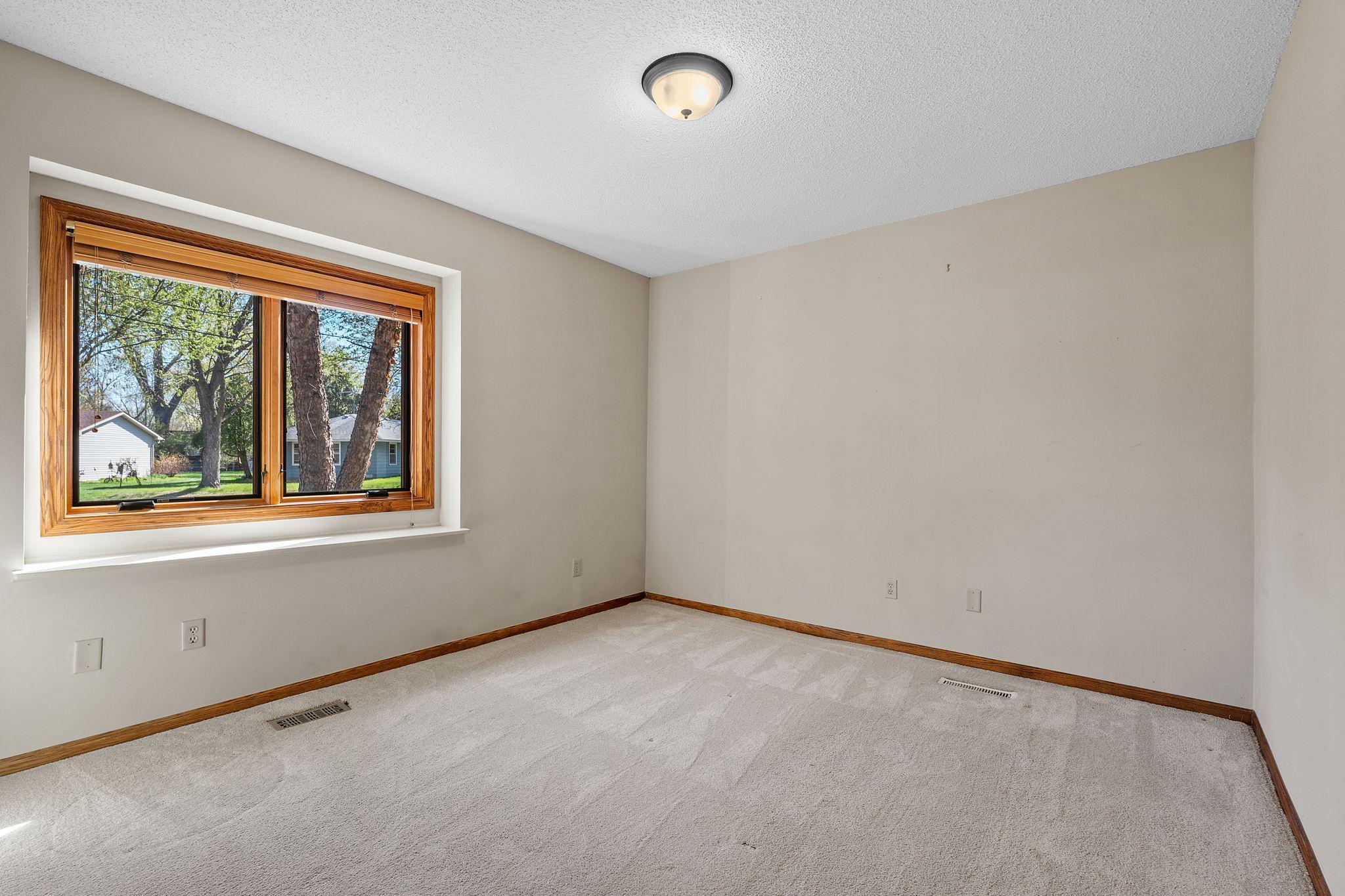 Two main-floor bedrooms provide comfortable living with natural light and closet space. These rooms offer flexibility for guests, family, or office use.