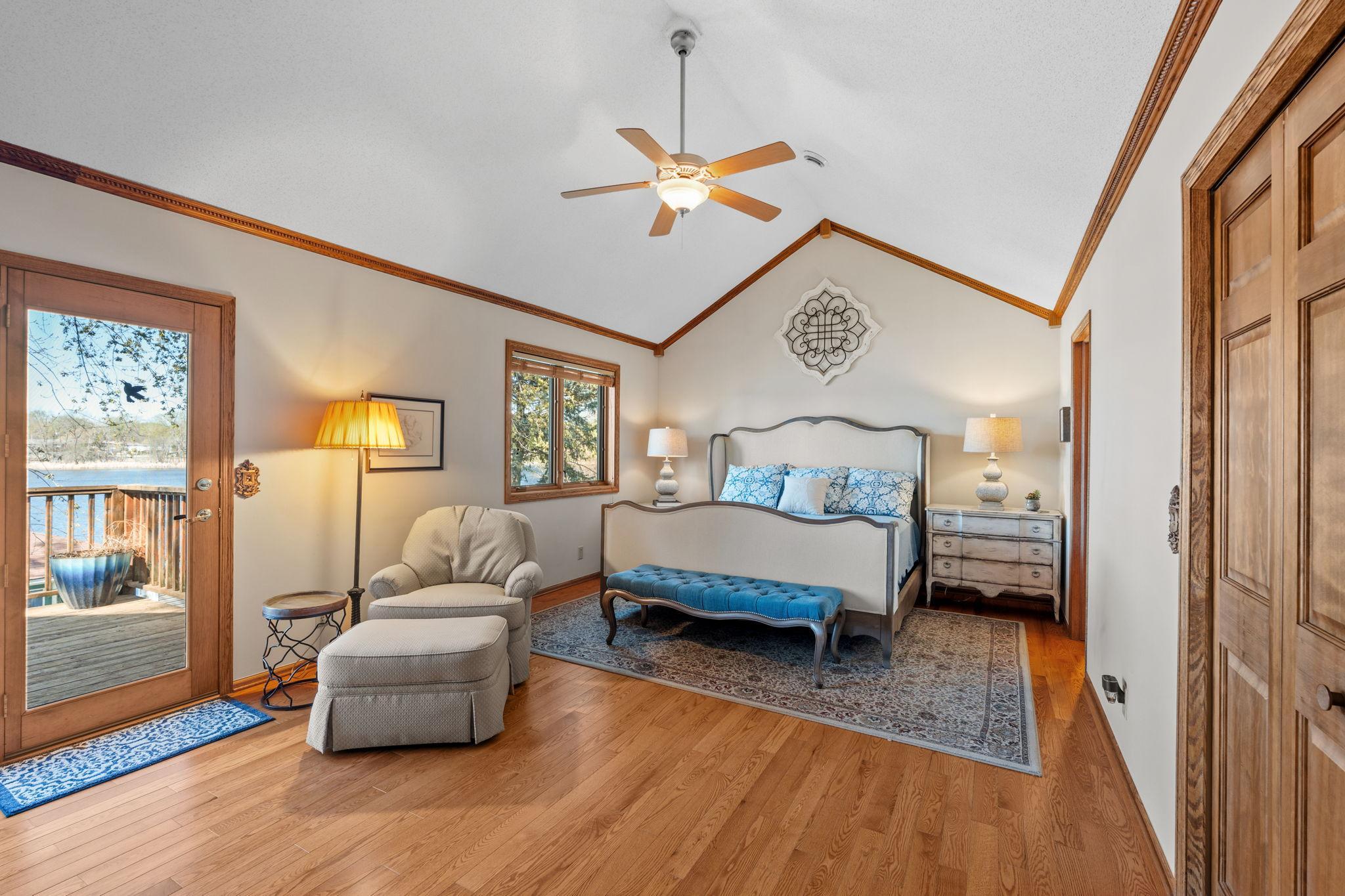 The primary bedroom features vaulted ceilings and direct access to a private deck. It’s a bright and relaxing retreat with beautiful views.