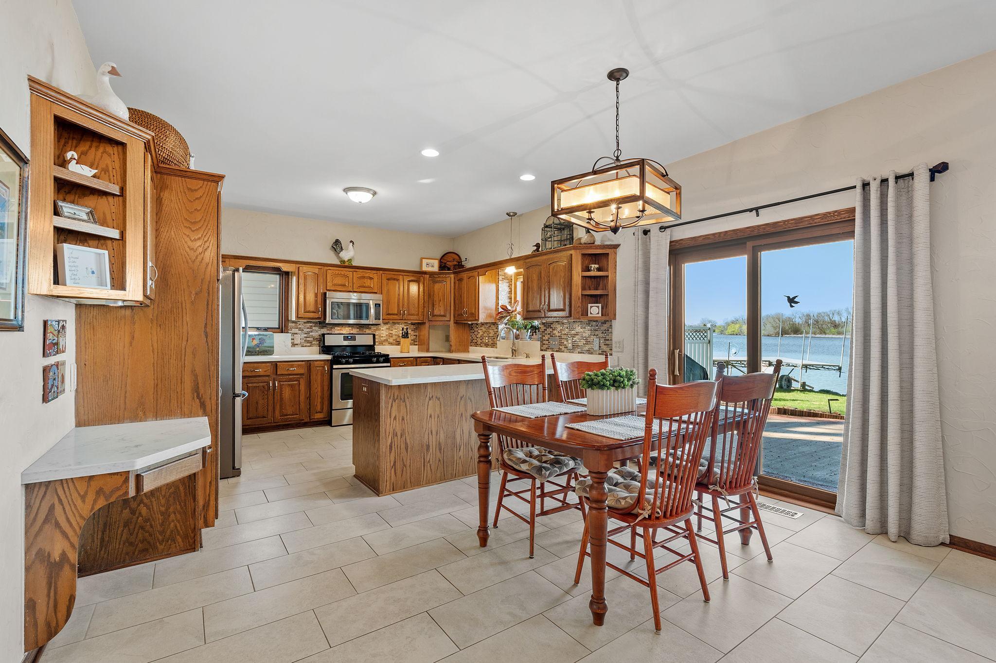 The dining area sits conveniently next to the kitchen, creating an ideal space for meals and gatherings. The layout enhances both function and flow.