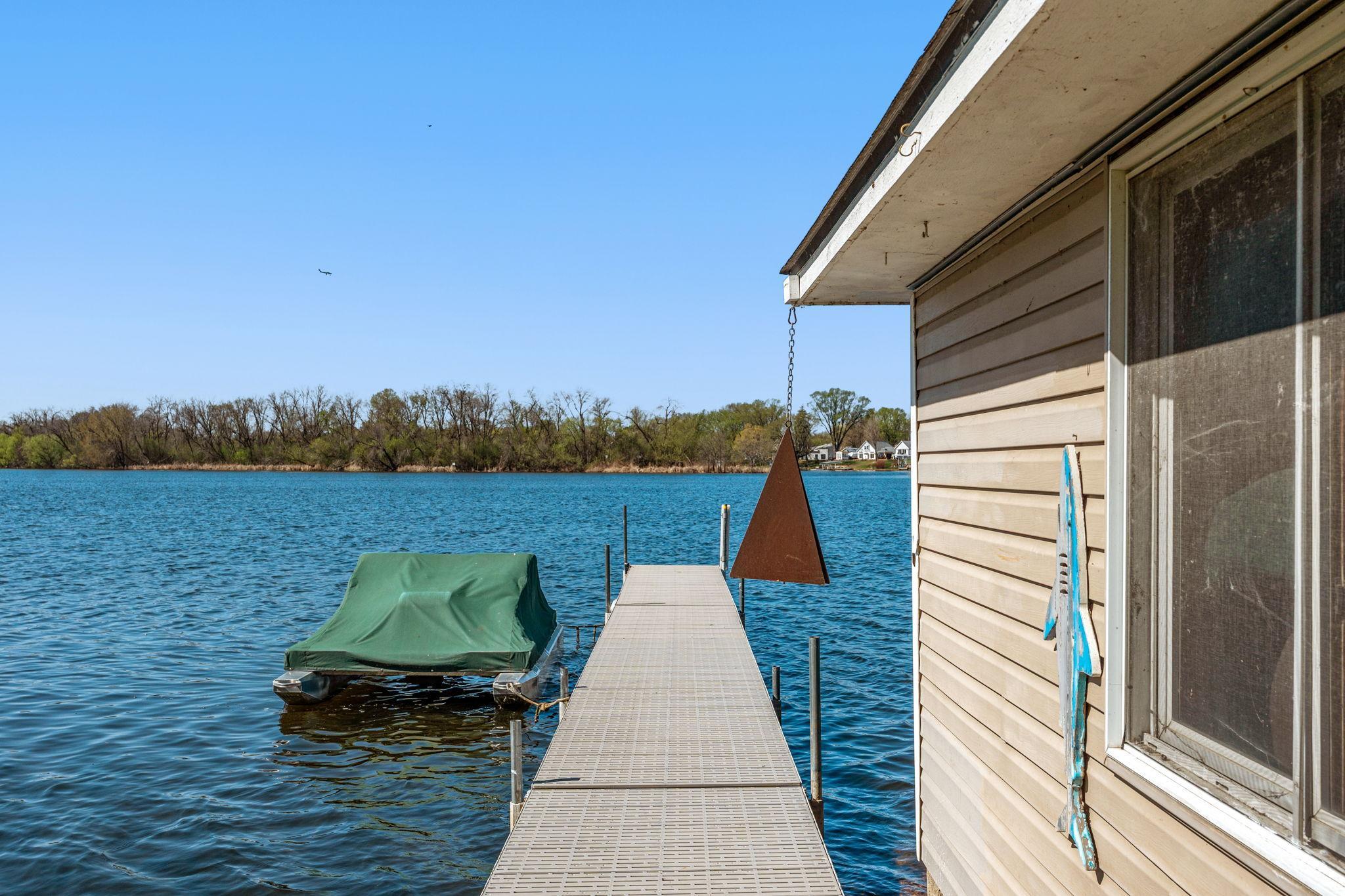 The dock provides easy access to the water, perfect for boating, kayaking, or simply enjoying the lake lifestyle.