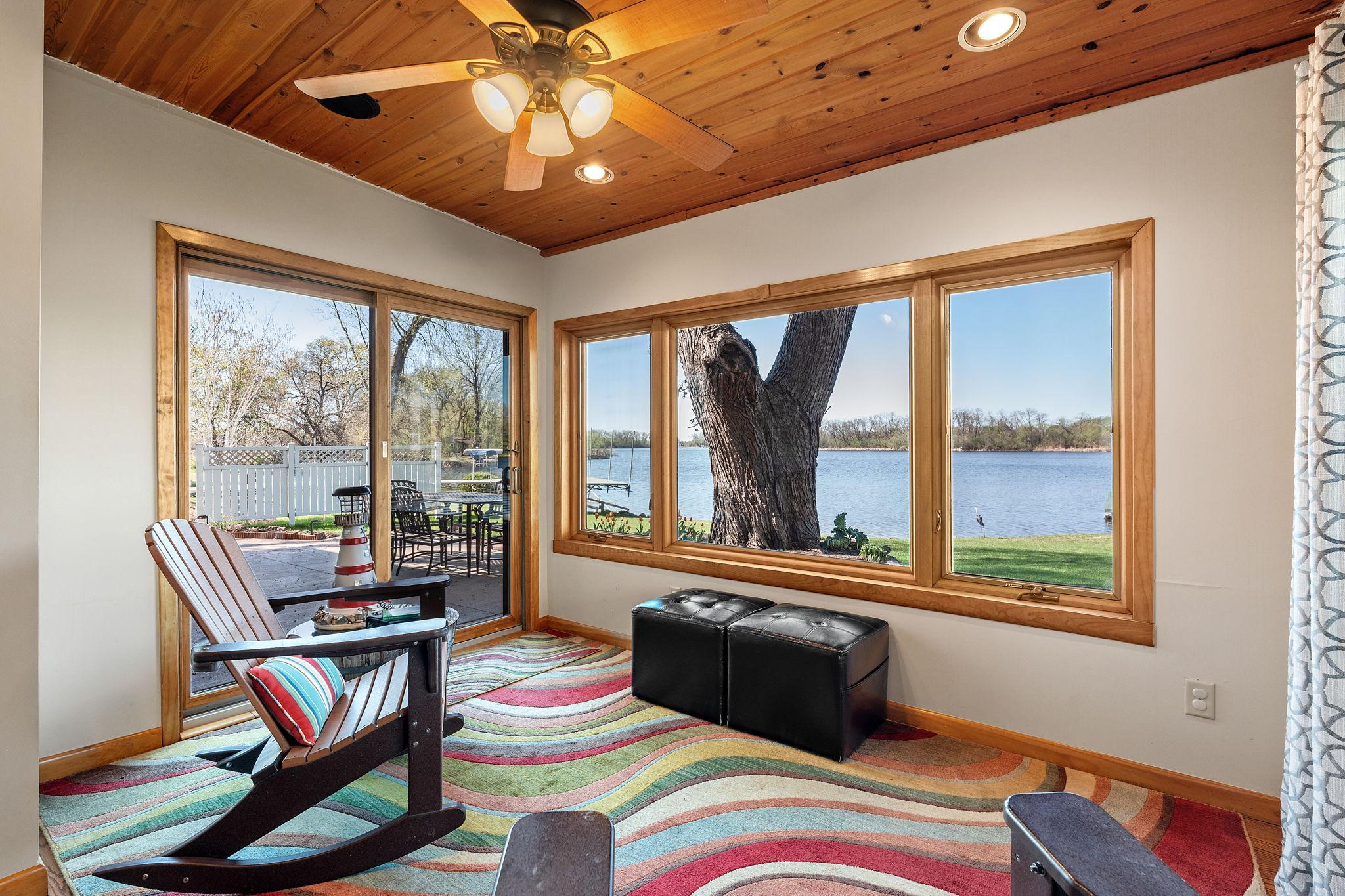 Enjoy stunning views of the backyard and lake from the sunroom, with direct access to the patio.