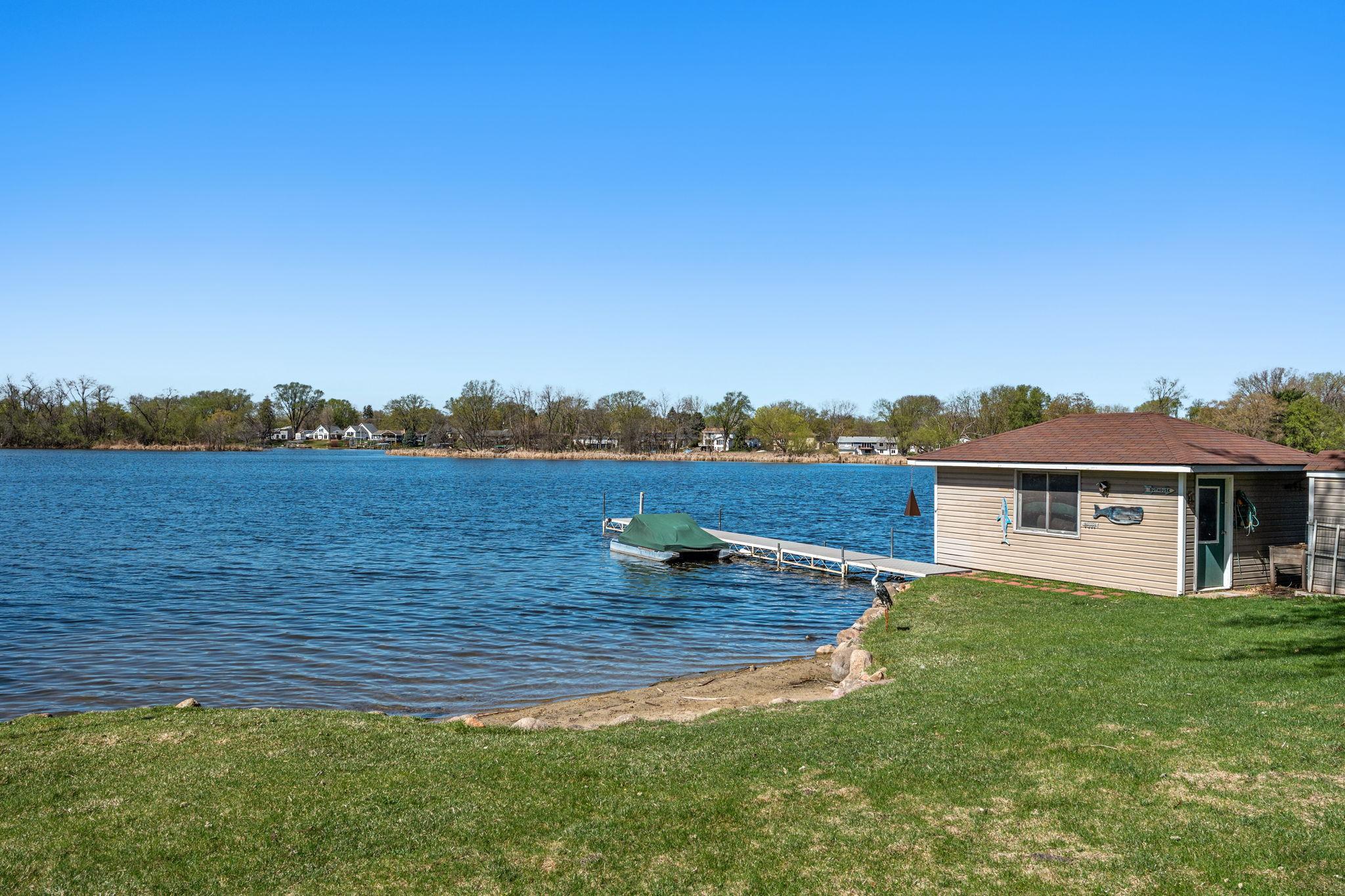 The backyard features a rare boathouse and dock, offering unmatched access to lake activities right at your doorstep.