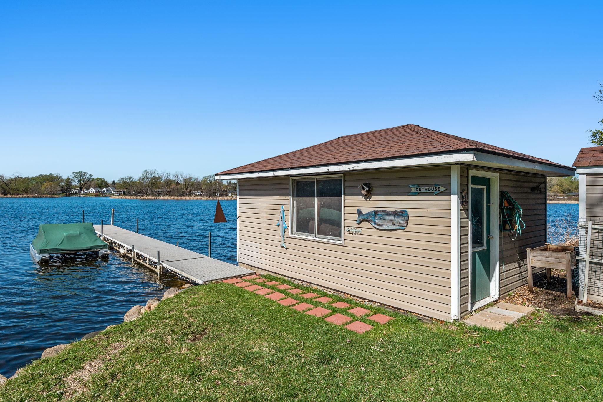 A closer look at the grandfathered boathouse and dock highlights the unique character and convenience of this lakefront property.