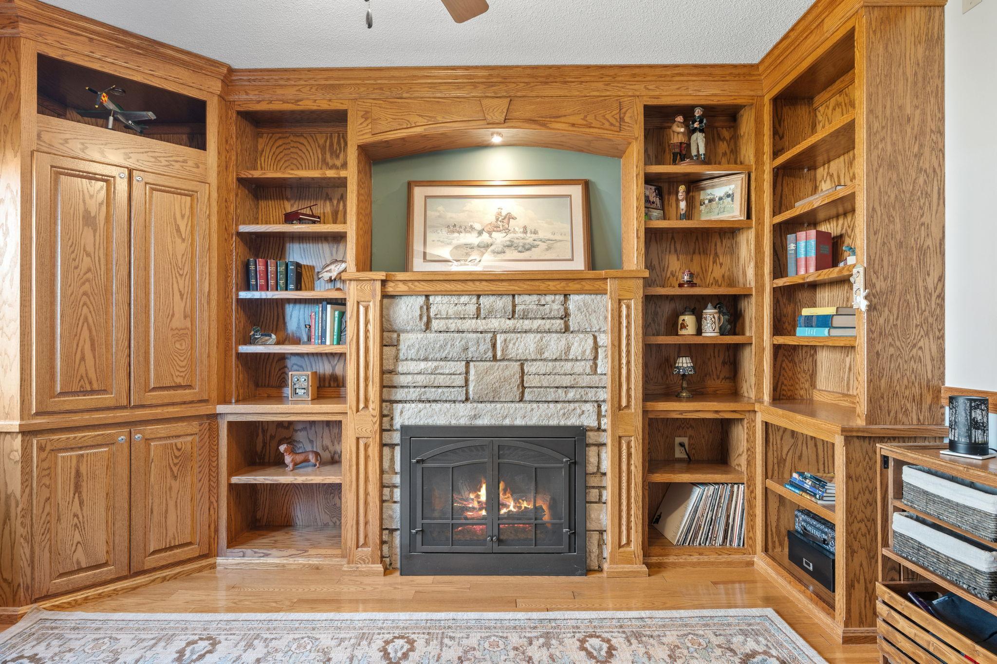 A fireplace surrounded by built-ins adds both warmth and character, creating a functional and stylish focal point in the space.