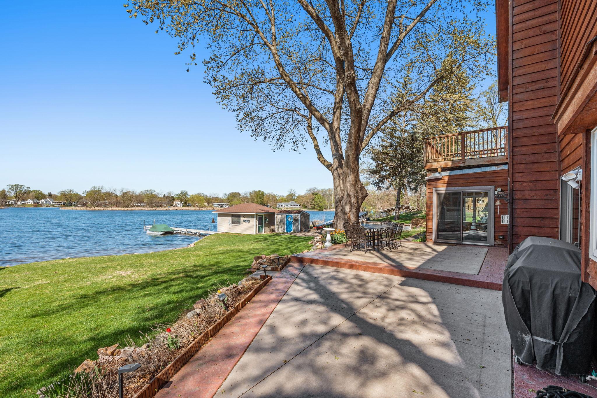 The patio connects to the sunroom and offers beautiful lake views, making it a perfect spot for outdoor living.