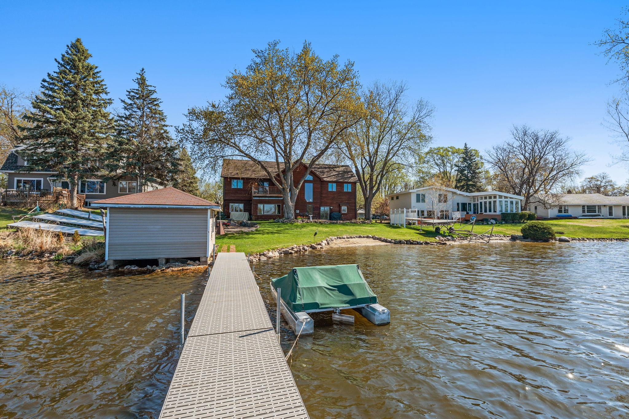 From the dock, take in a full view of the home, showcasing its impressive design and lakefront presence.