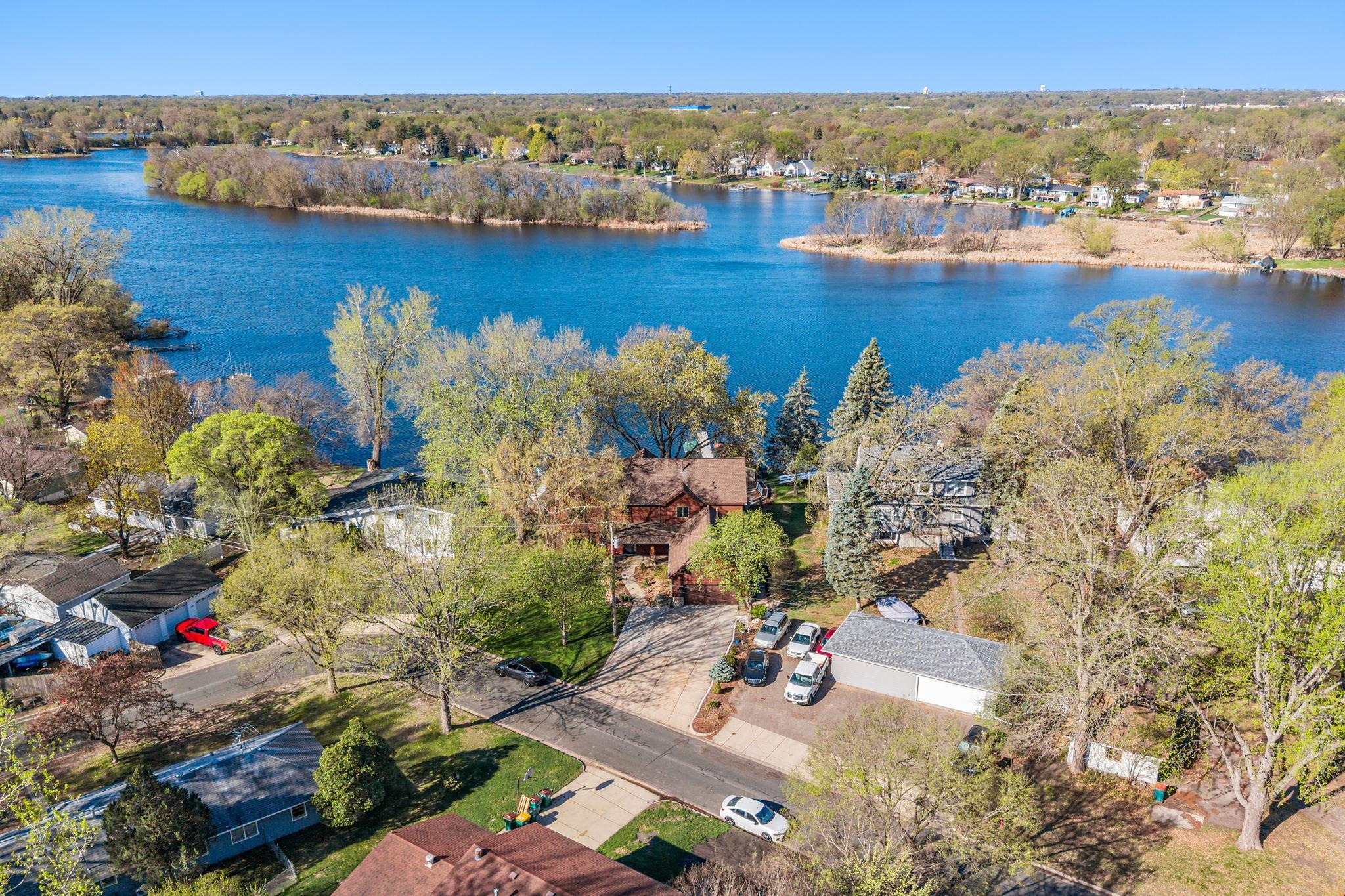 This elevated perspective highlights the connection between the home and the lake, emphasizing the lifestyle it offers.