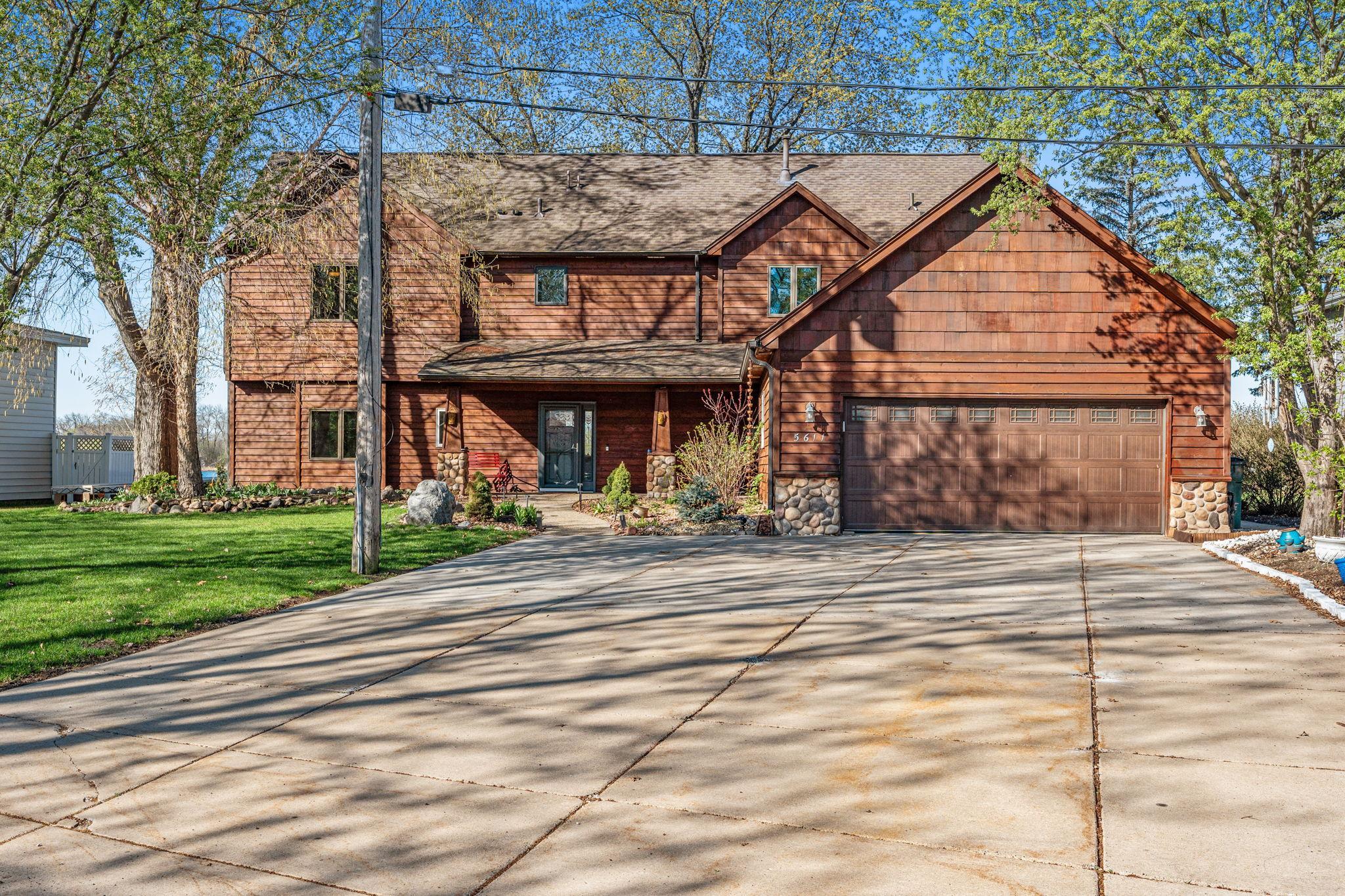 A generous driveway and clean exterior presentation set the tone for this beautifully maintained home.