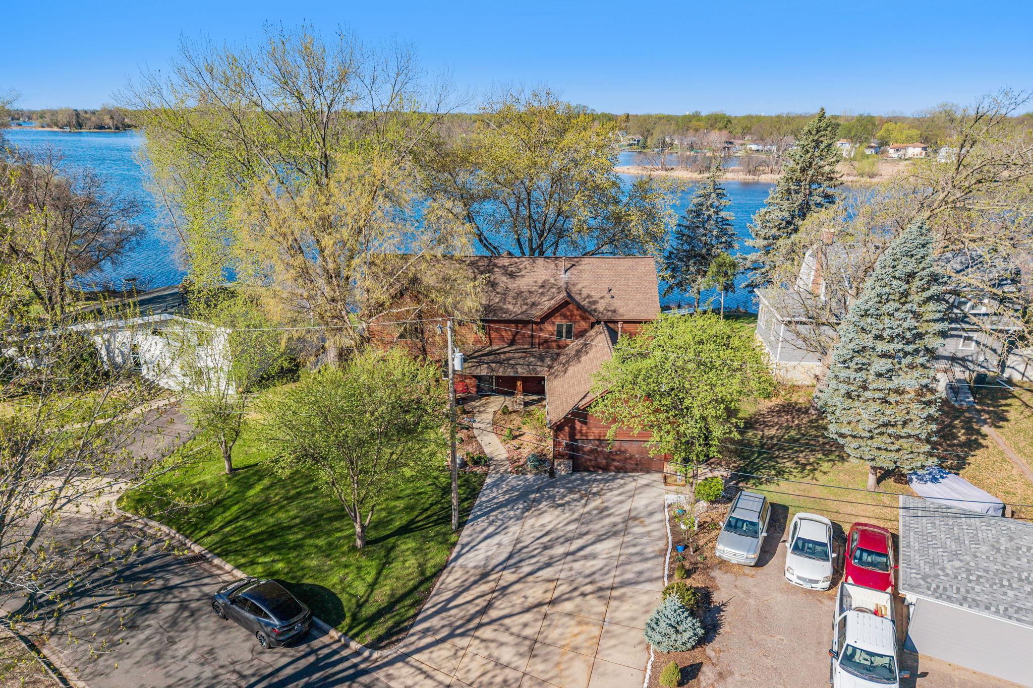 A complete aerial view showcases the entire property, from the home to the shoreline, illustrating its exceptional lakefront appeal.