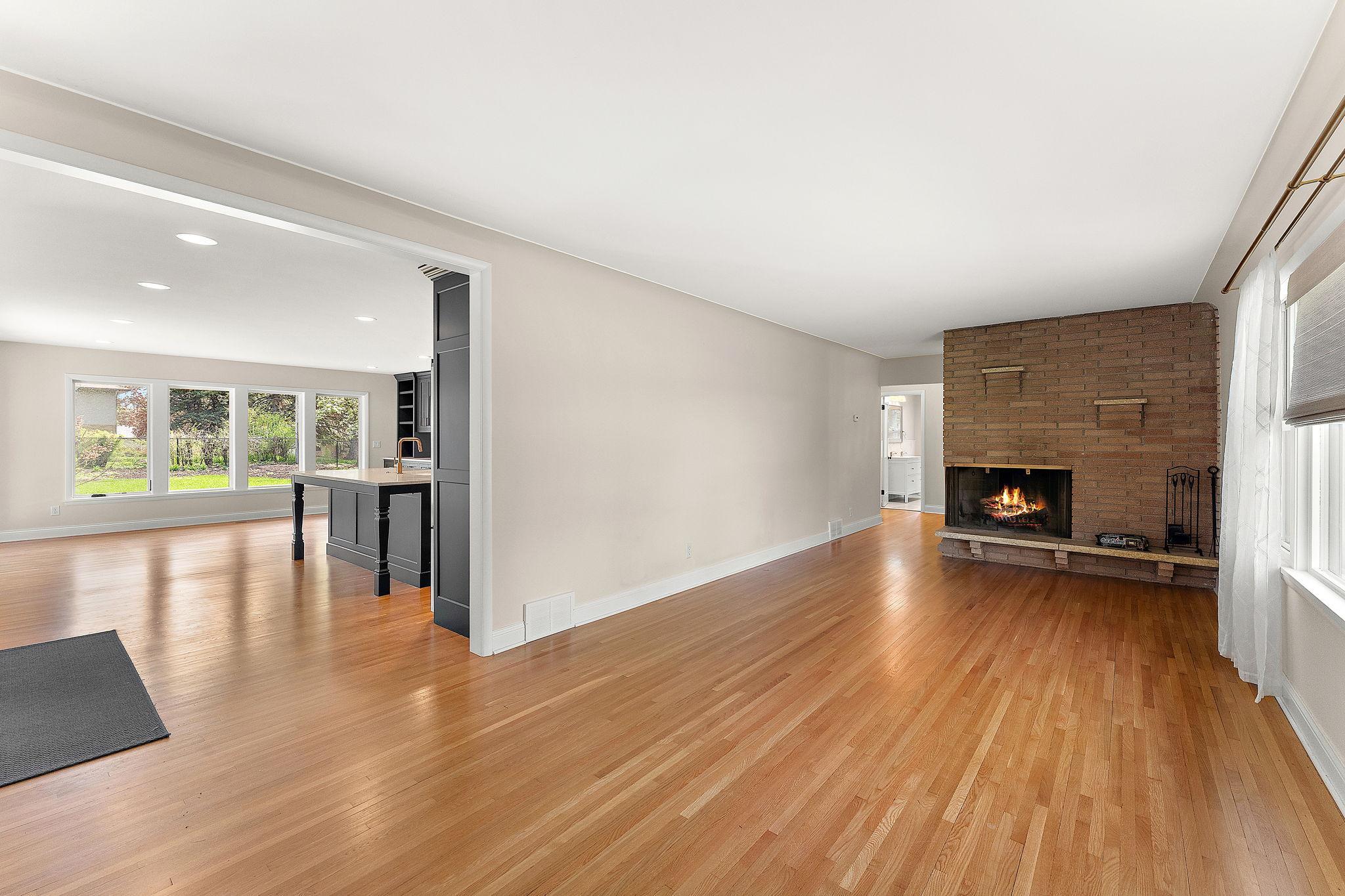 The living room has the first of two wood-burning fireplaces, with the classic Mid- Century Modern brick feature.