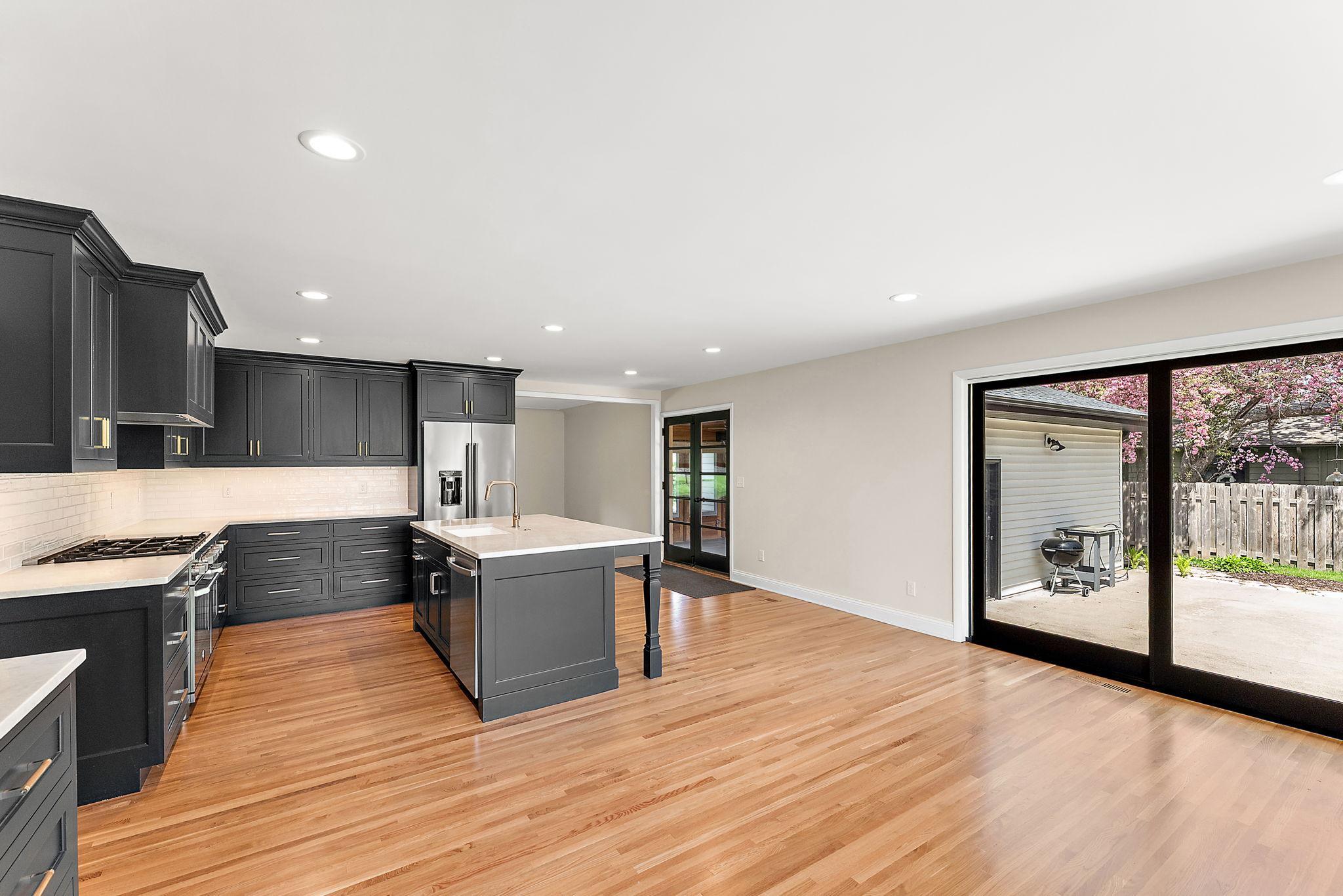 The kitchen dining area walks out to a patio and a large, fenced-in back yard.