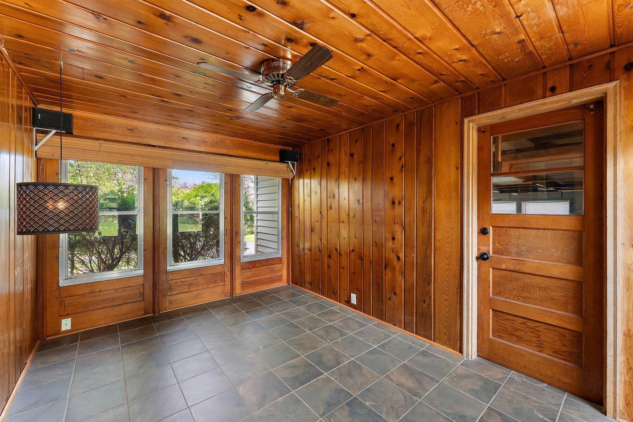 The three season porch connects the garage to the home & walks out to the back yard.