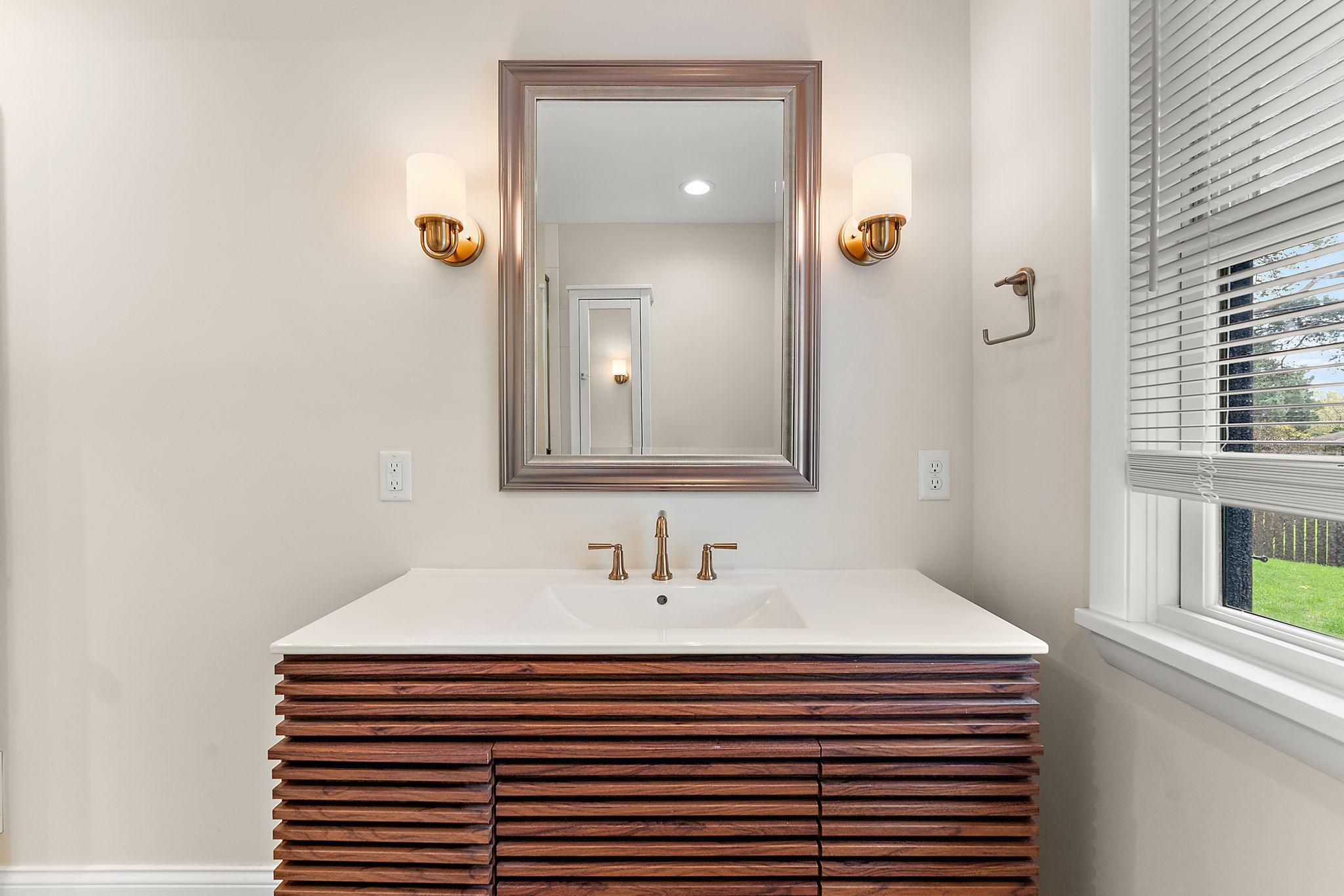 Beautiful wood primary vanity featuring Delta Champagne Bronze Saylor faucet.
