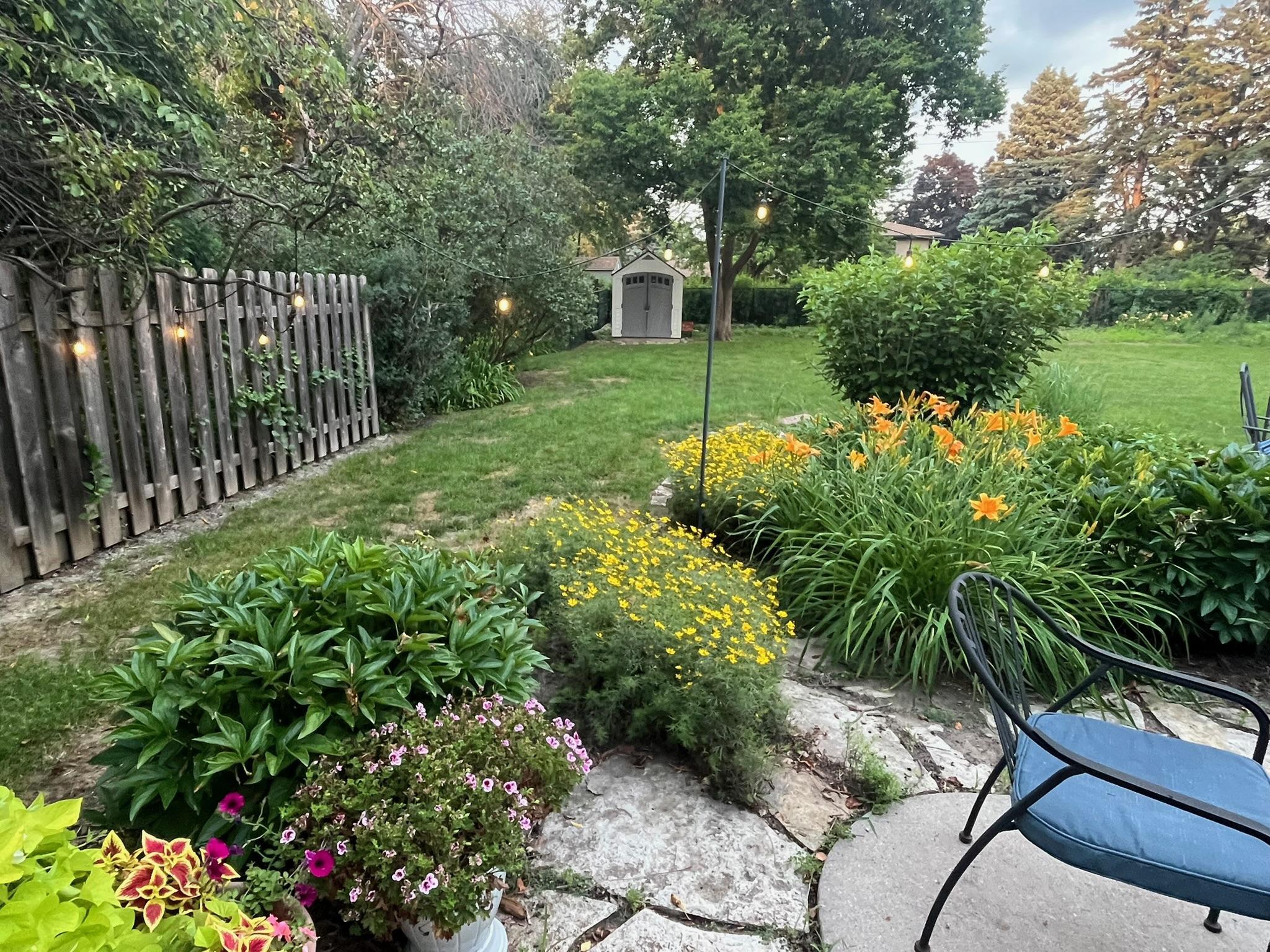 Perennial plantings of coreopsis, daylilies & peonies.