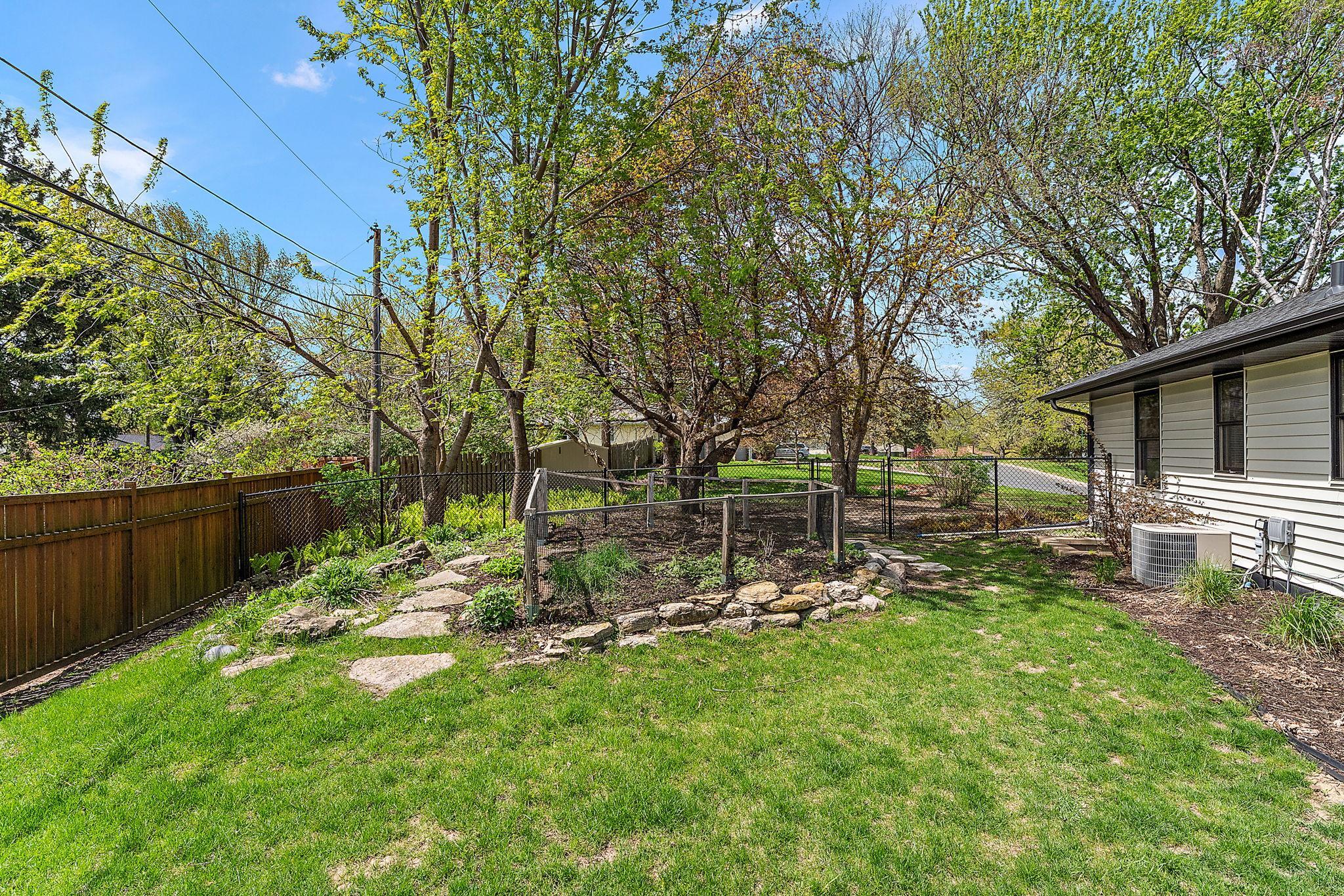 The South side of the home has a fenced-in area for a vegetable garden.