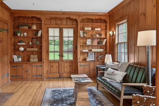 This charming den, with wood burning fireplace, walks out into the back yard.