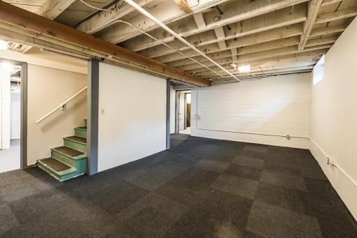 The spotless lower level offers excellent ceiling height, a flexible recreation space, plus expansive laundry and storage areas.