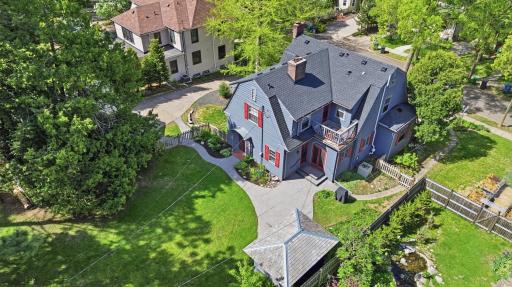 The oversized lot features lush perennial gardens.