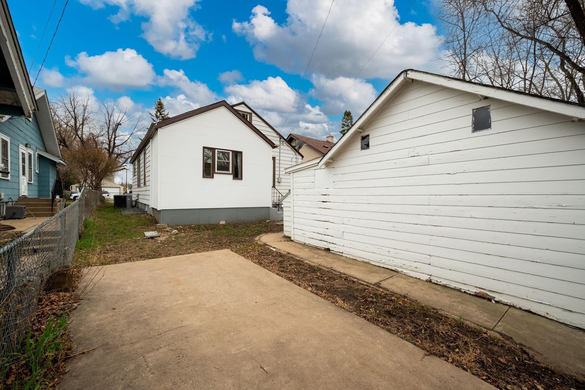 Fence gate opens to the extra parking pad, or this could be used as patio space!