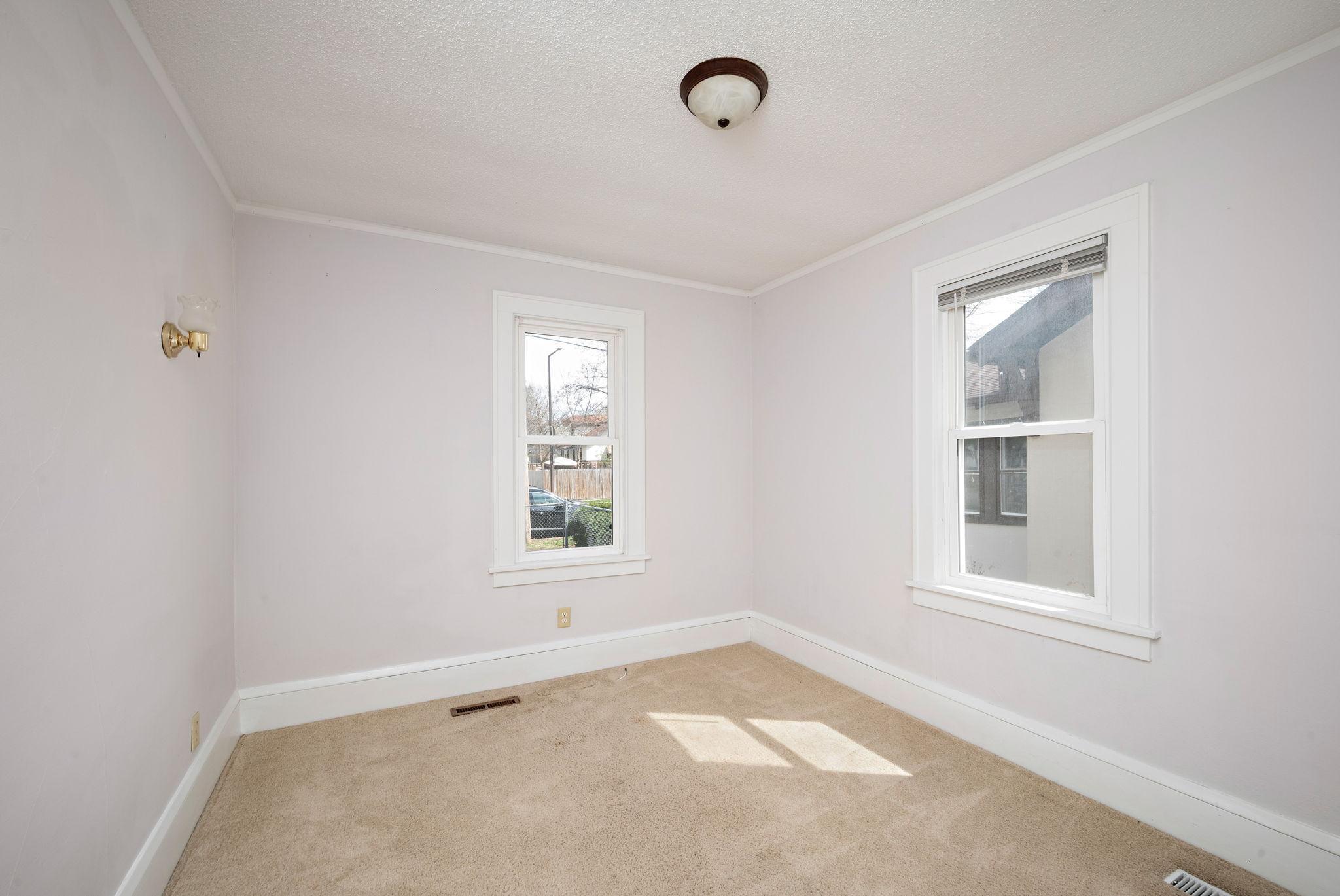 Main floor bedroom, southeast corner. Both main floor bedrooms have new carpet.