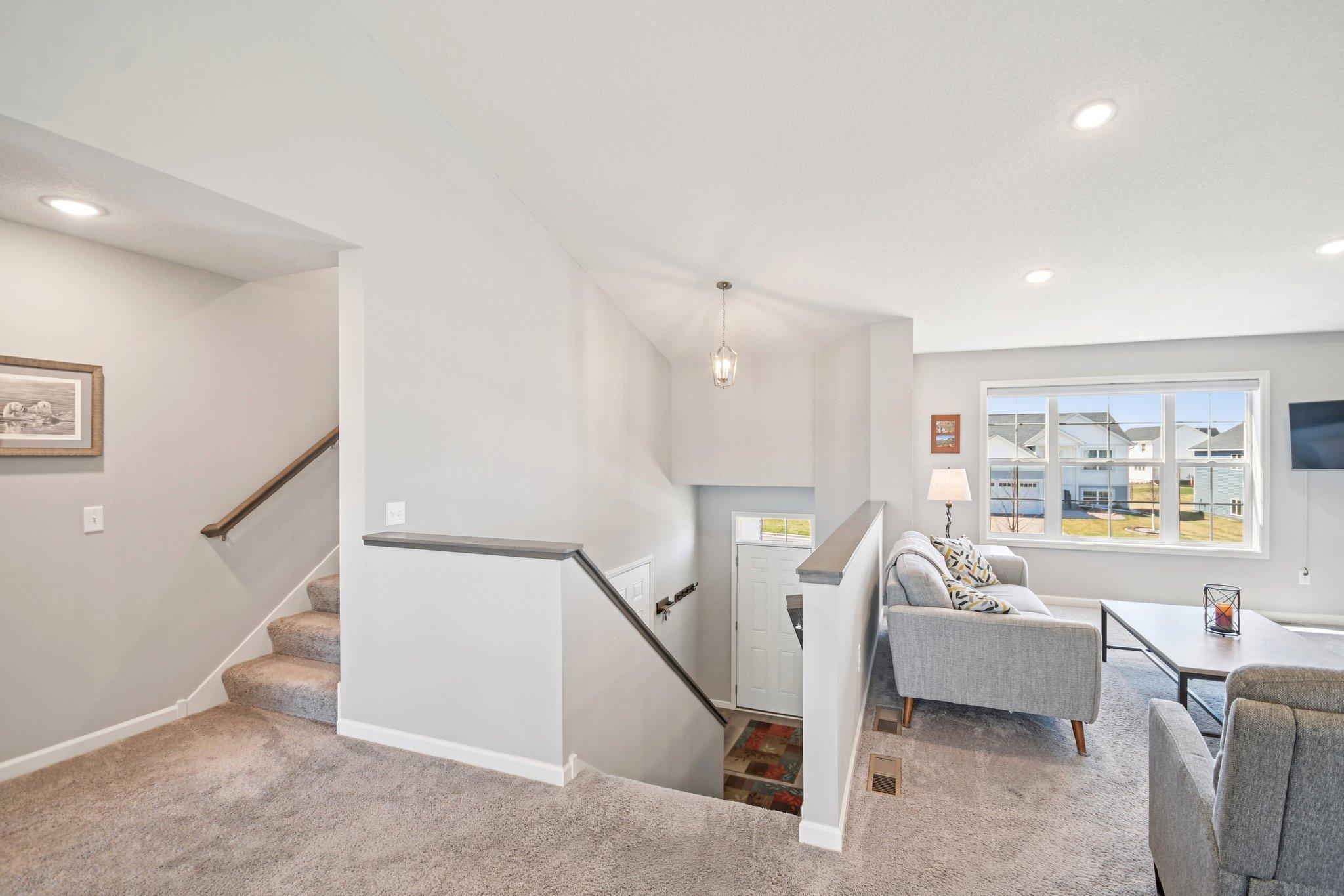 Stairs on left lead to the private primary suite