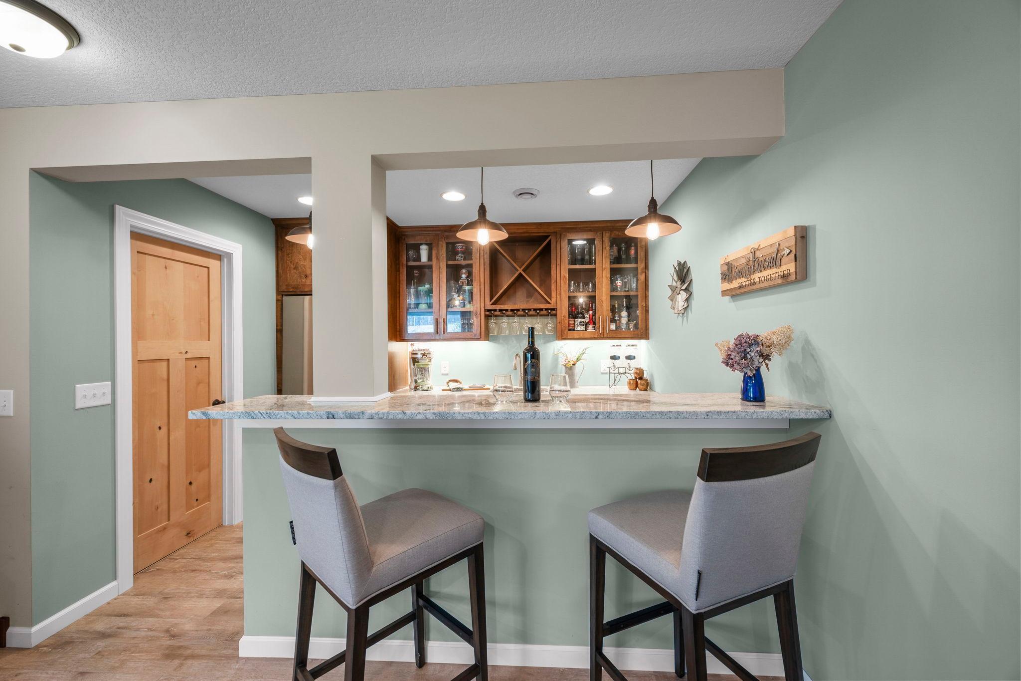 Kitchenette/bar area with stone countertops