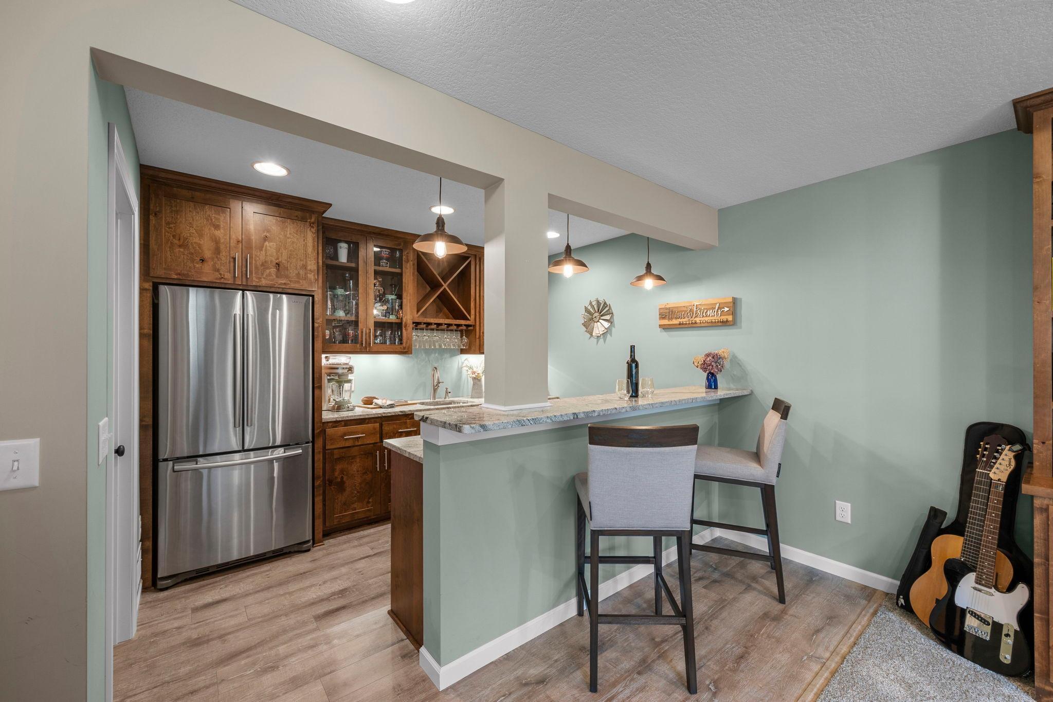 On-trend lighting, sink and full-size fridge