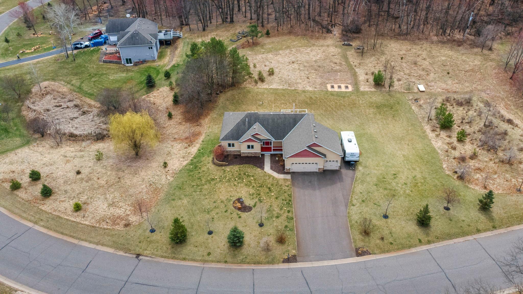 Lawn irrigation system; young trees; woods at the back lot line